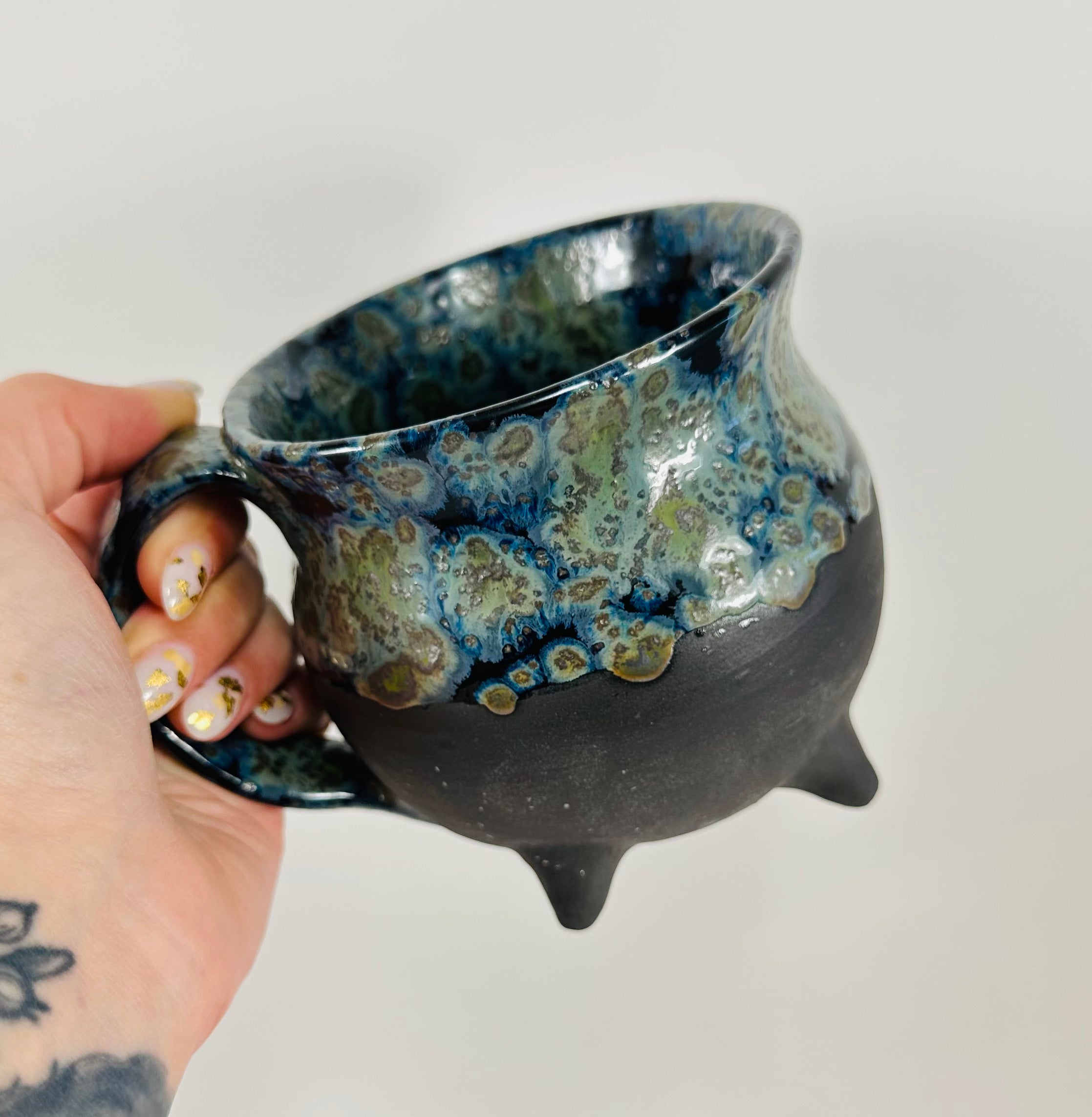Handmade cauldron mug in a beautiful blue, green and black glaze