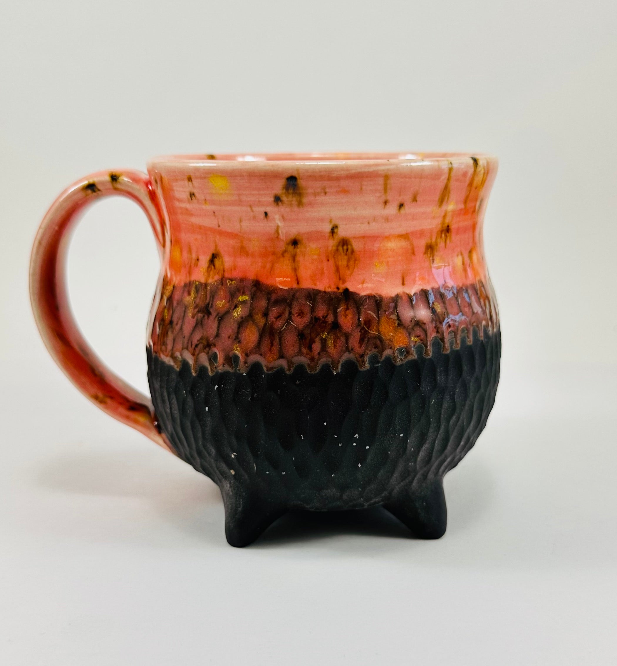 Handmade cauldron mug in a beautiful orange and black glaze
