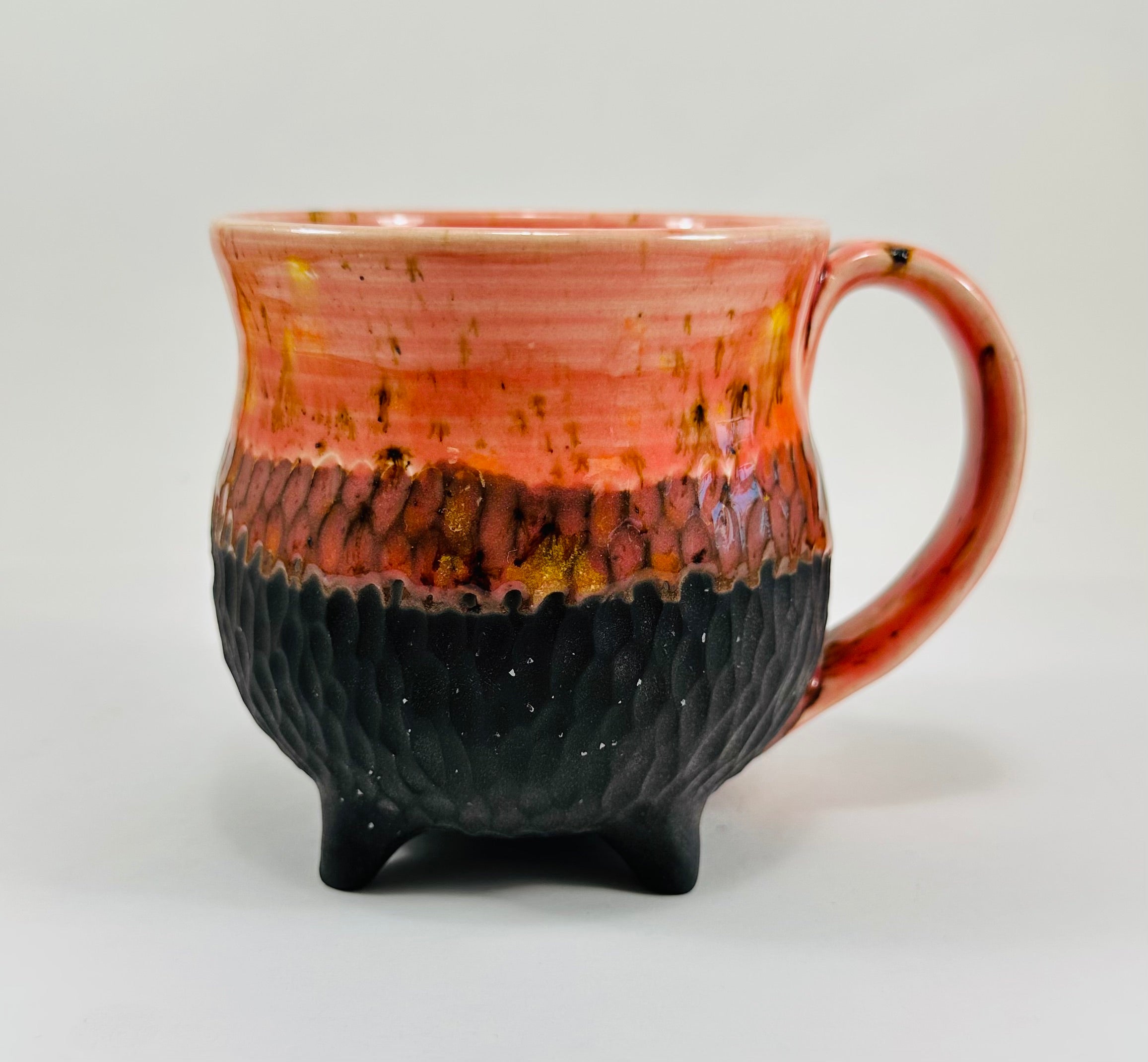 Handmade cauldron mug in a beautiful orange and black glaze