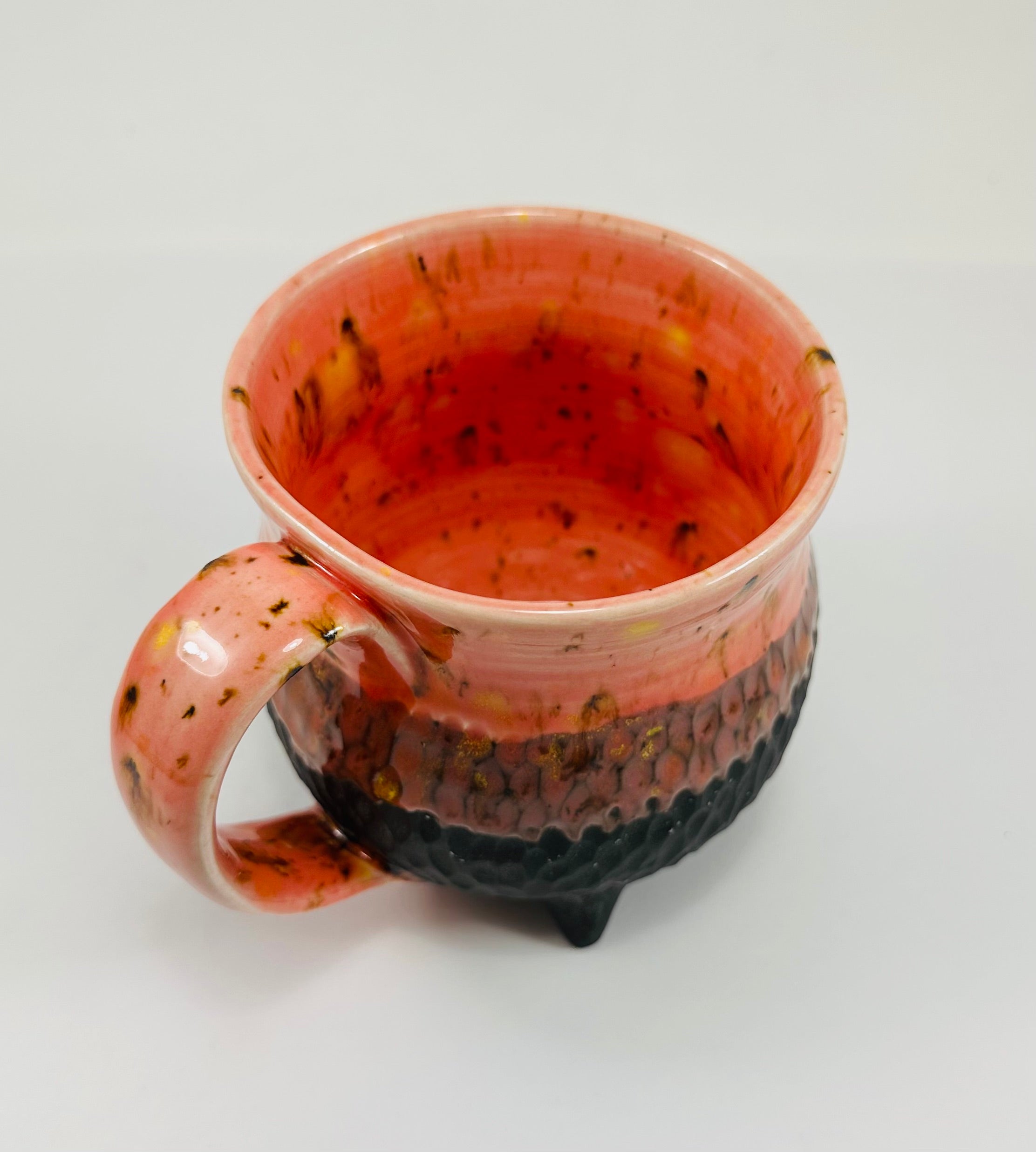 Handmade cauldron mug in a beautiful orange and black glaze