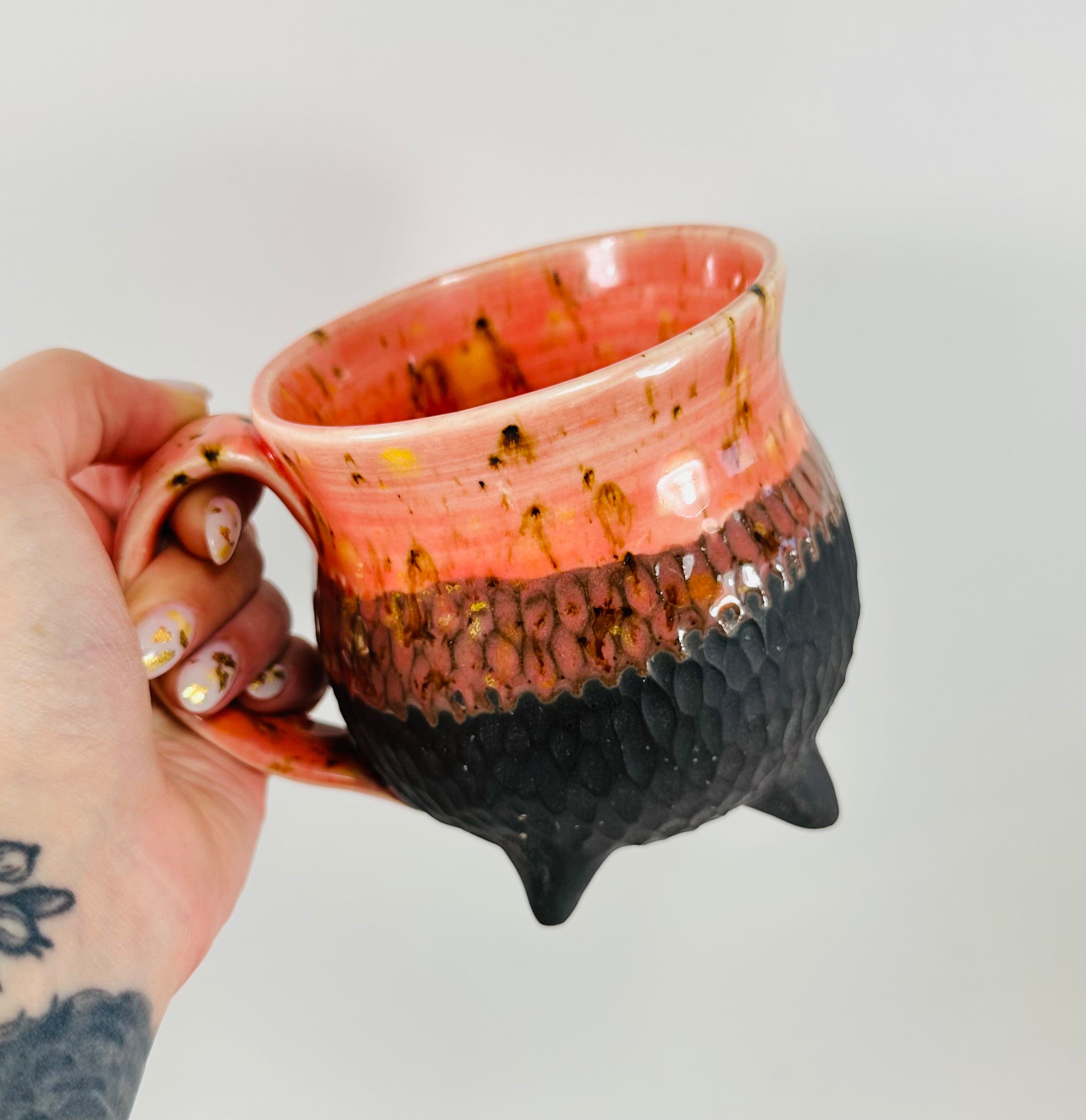 Handmade cauldron mug in a beautiful orange and black glaze