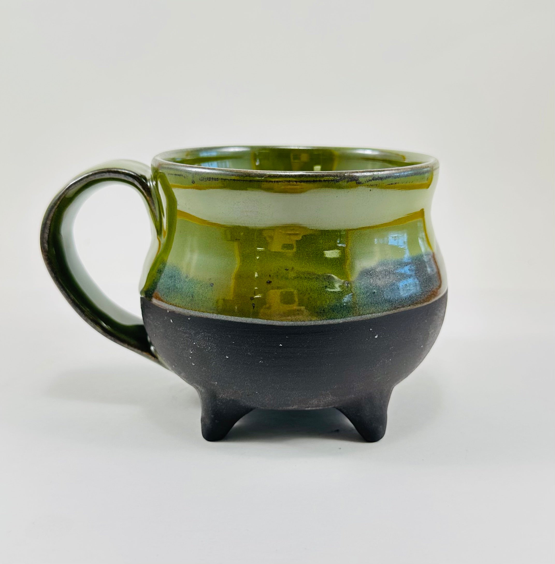 Handmade cauldron mug in a beautiful green and black glaze