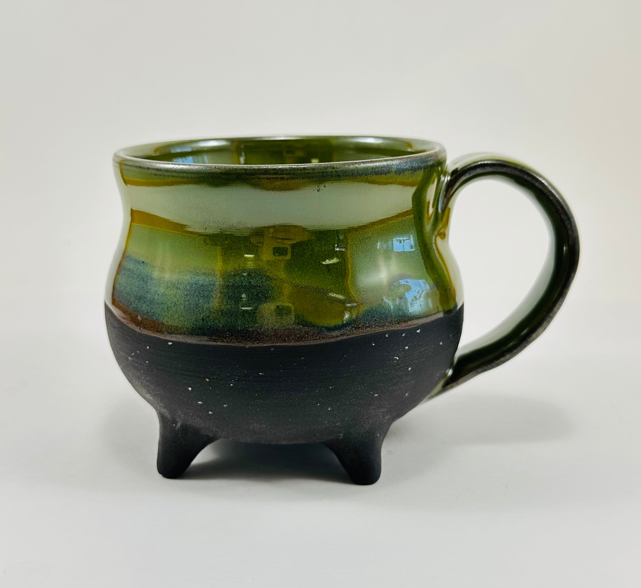 Handmade cauldron mug in a beautiful green and black glaze