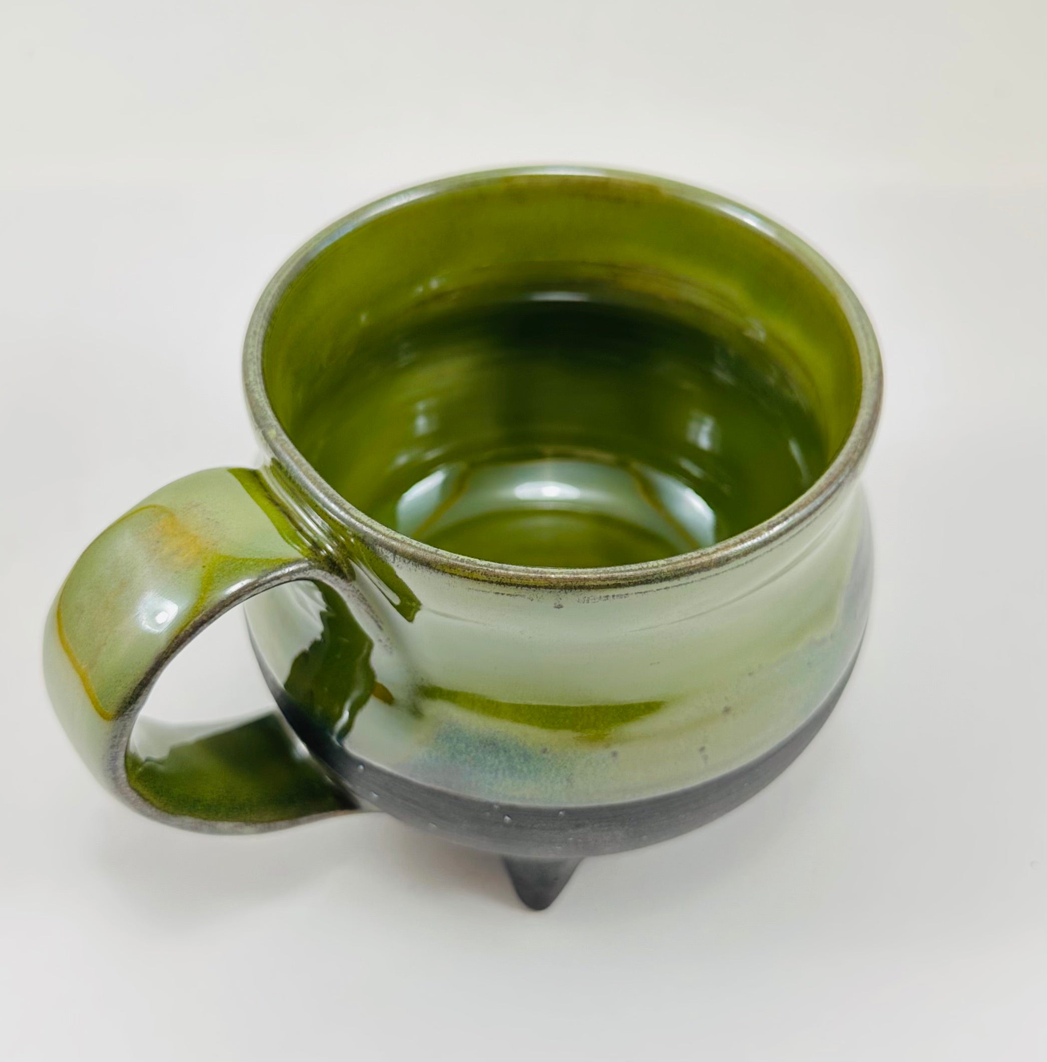 Handmade cauldron mug in a beautiful green and black glaze
