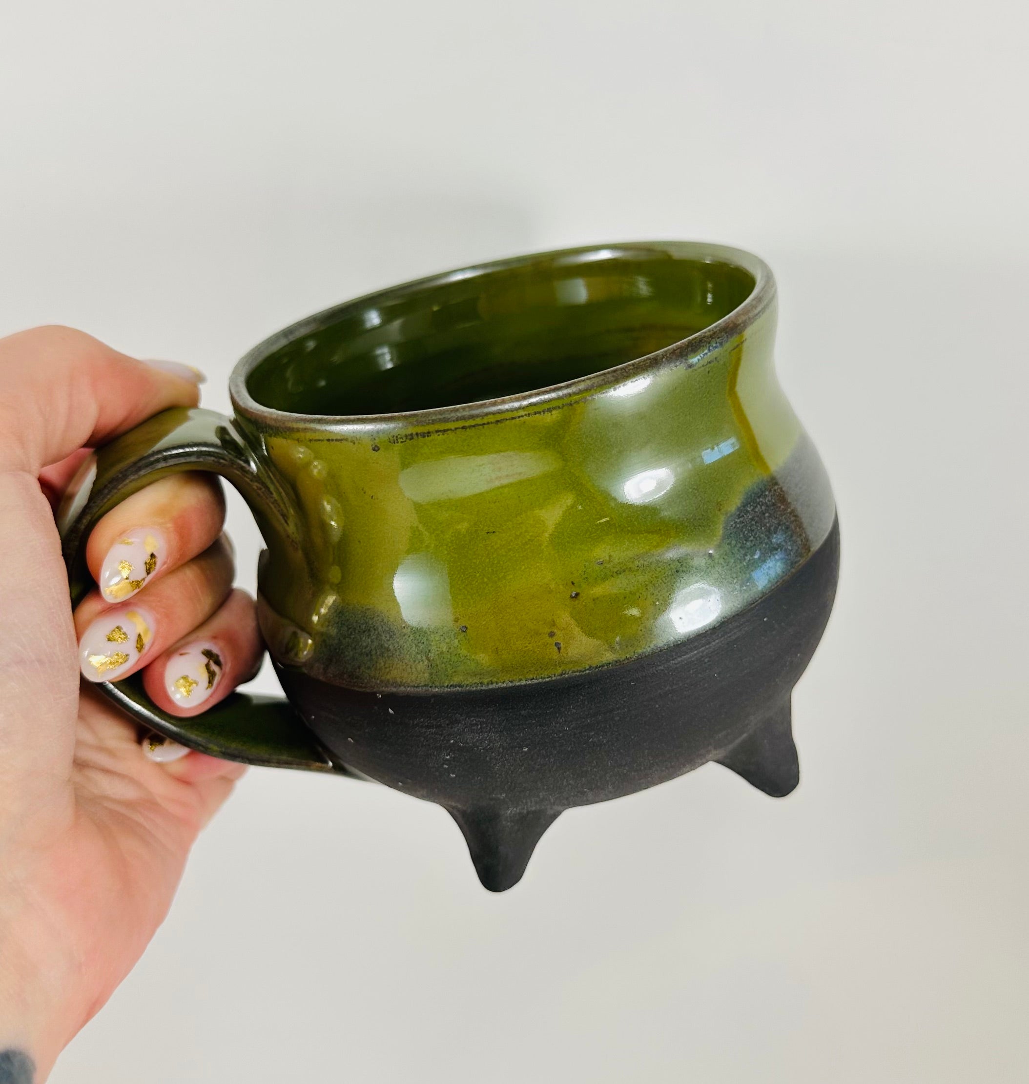 Handmade cauldron mug in a beautiful green and black glaze