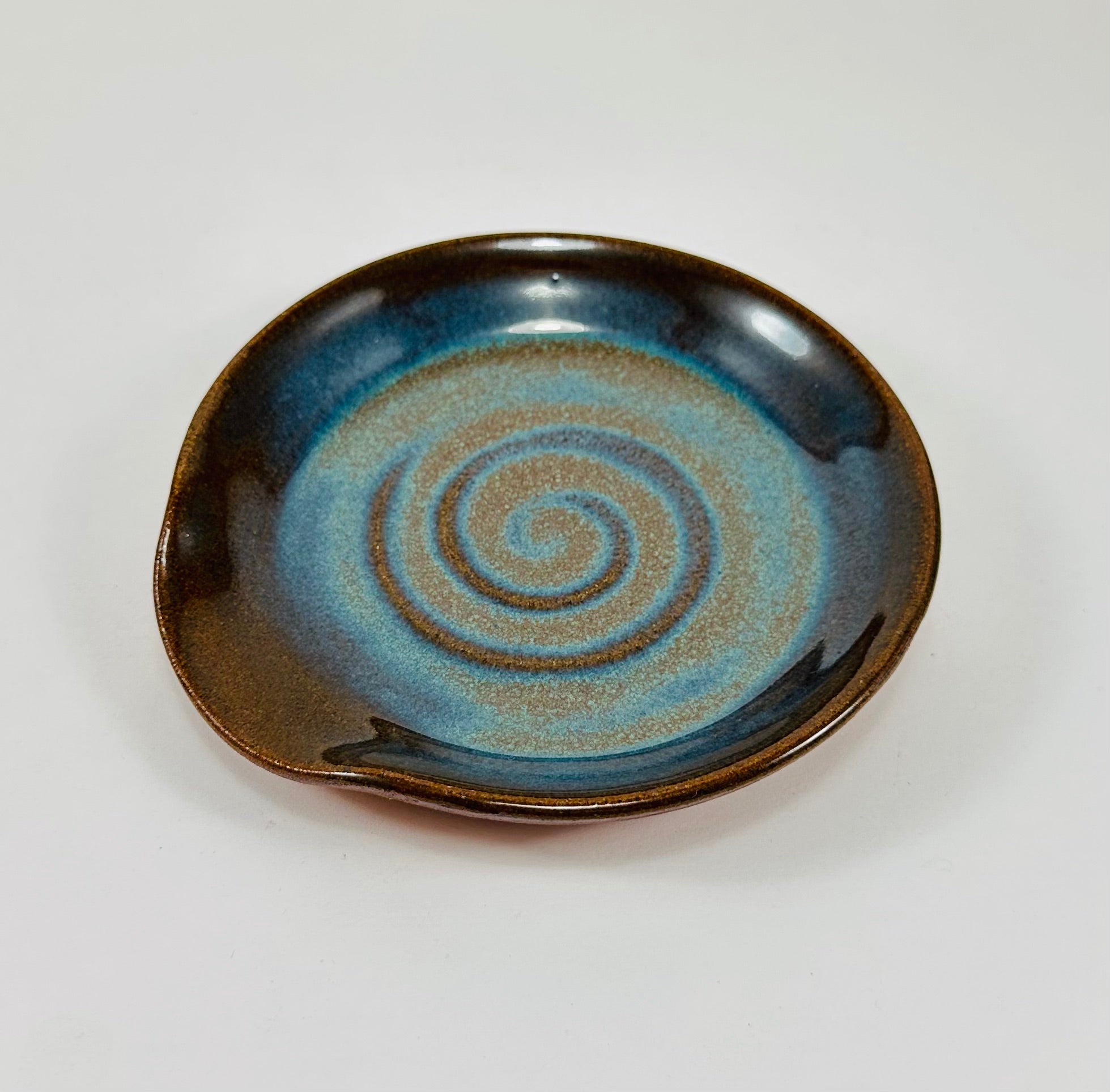 Handmade spoon rest in a beautiful blue and brown glaze.