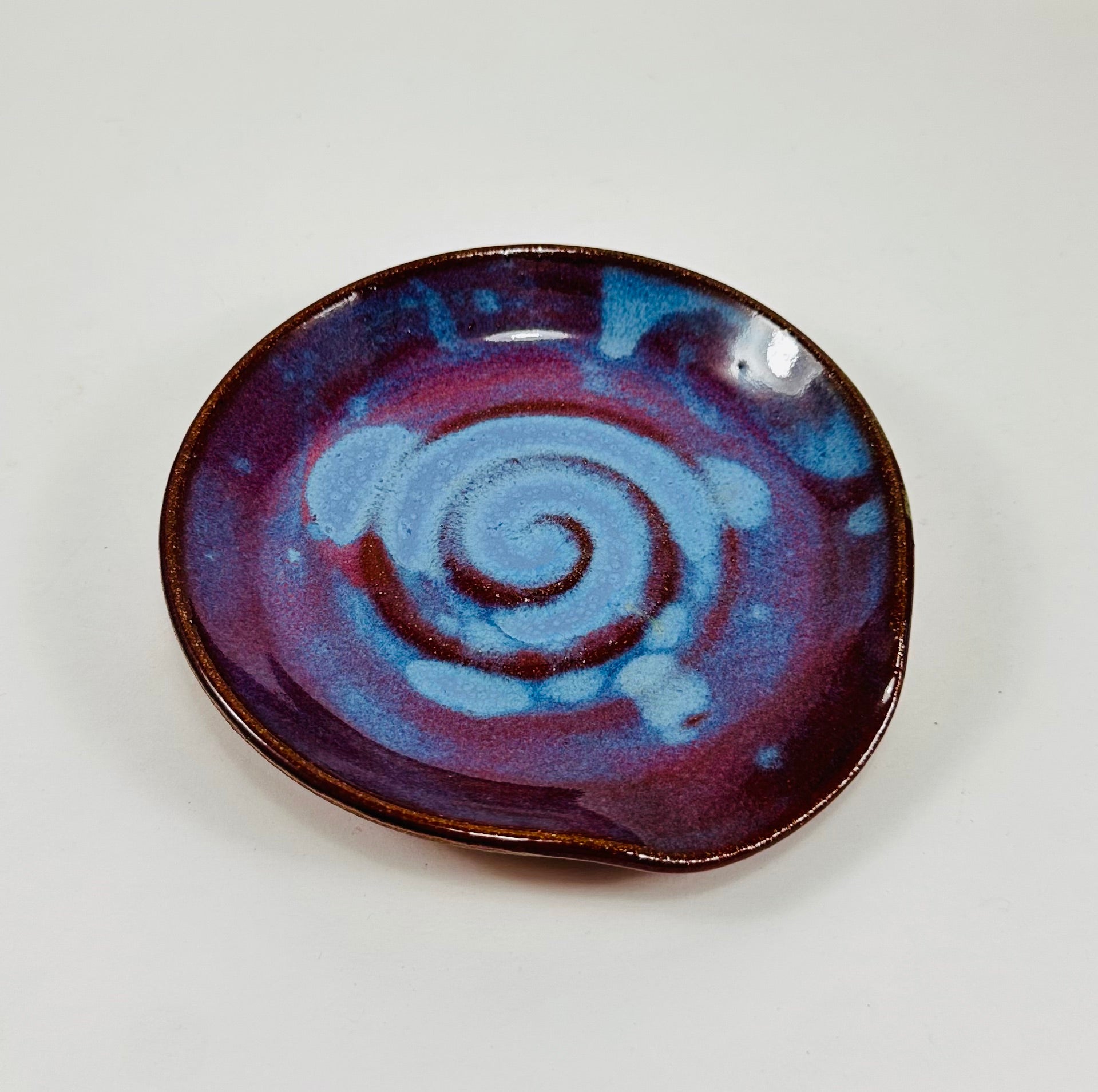 Handmade spoon rest in a beautiful purple and blue glaze.