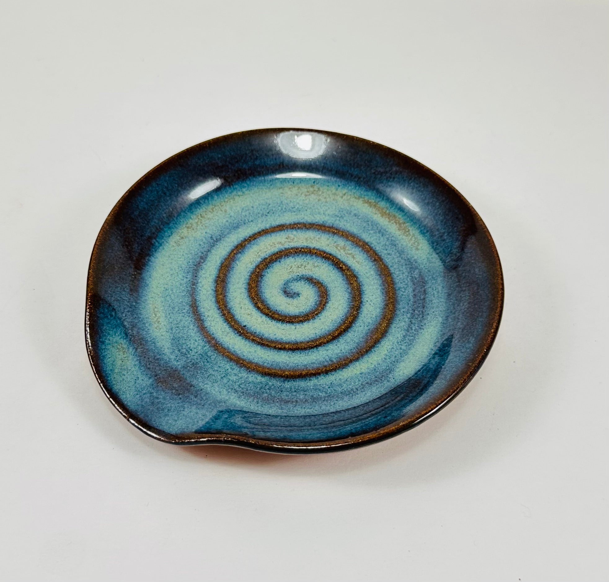 Handmade spoon rest in a beautiful green and blue glaze.