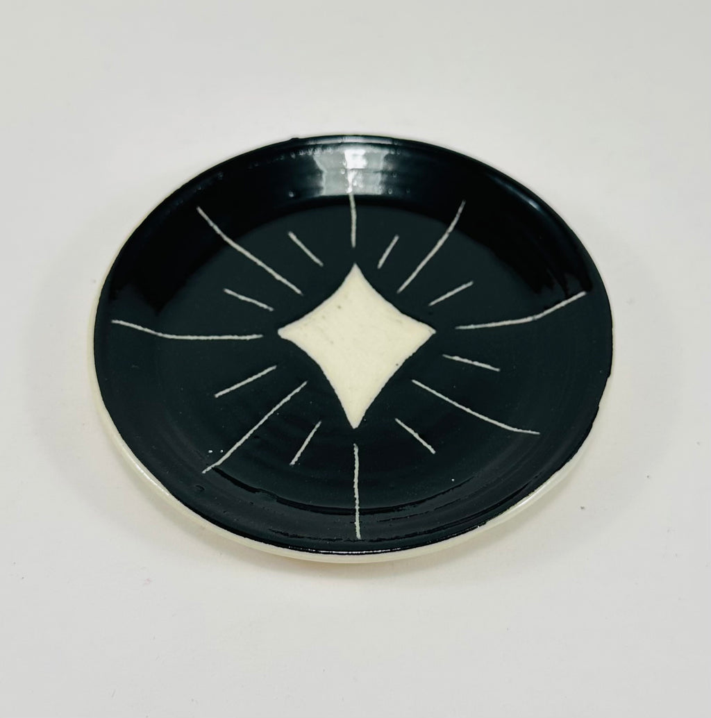 Handmade trinket dish in  black and white glaze with stars.