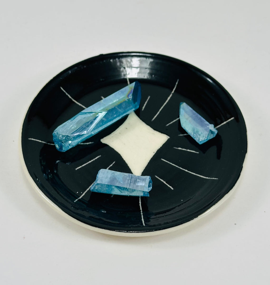 Handmade trinket dish in  black and white glaze with stars.