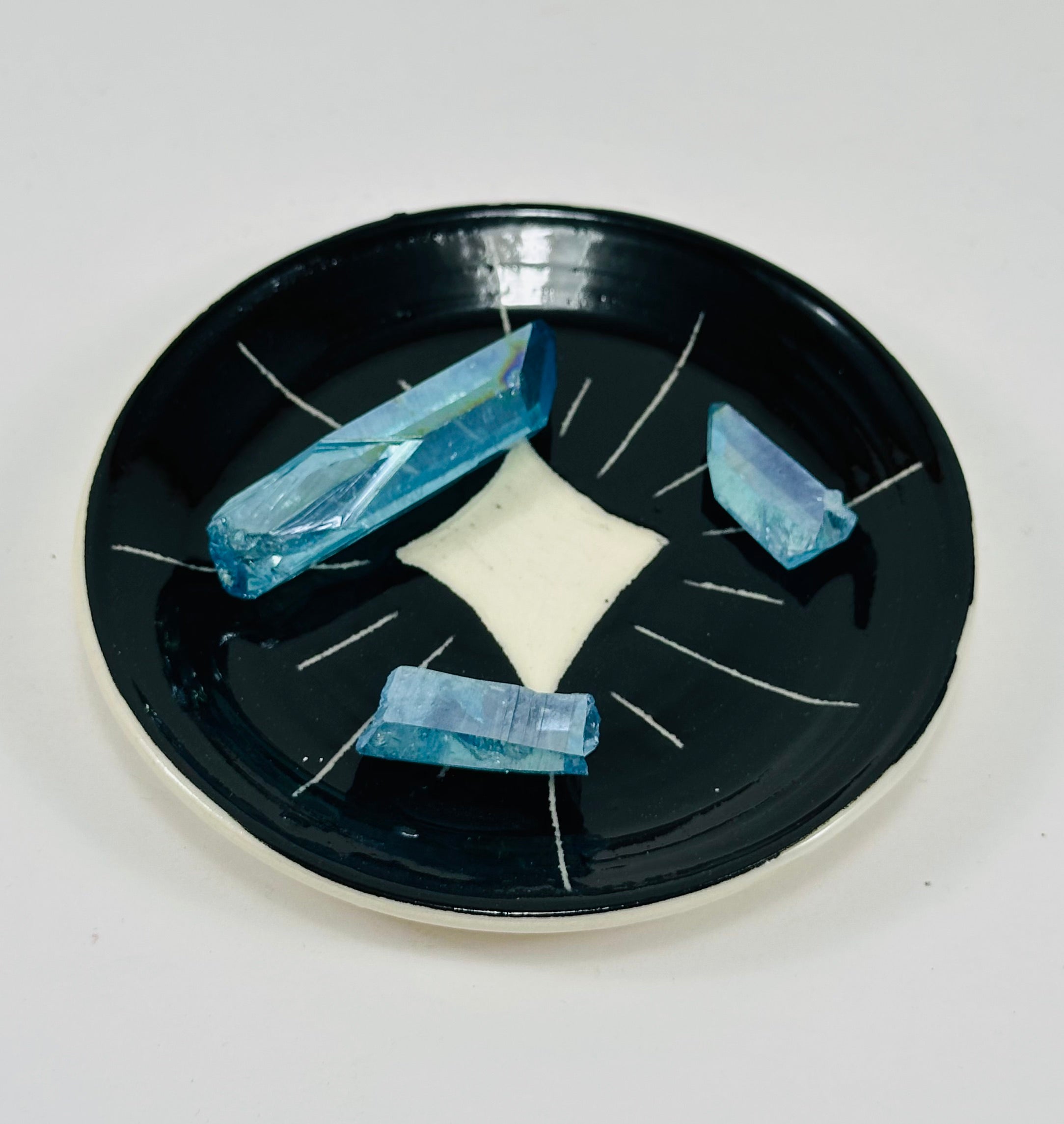 Handmade trinket dish in  black and white glaze with stars.