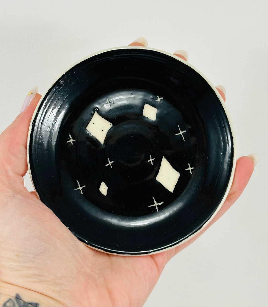 Handmade trinket dish in  black and white glaze with stars.