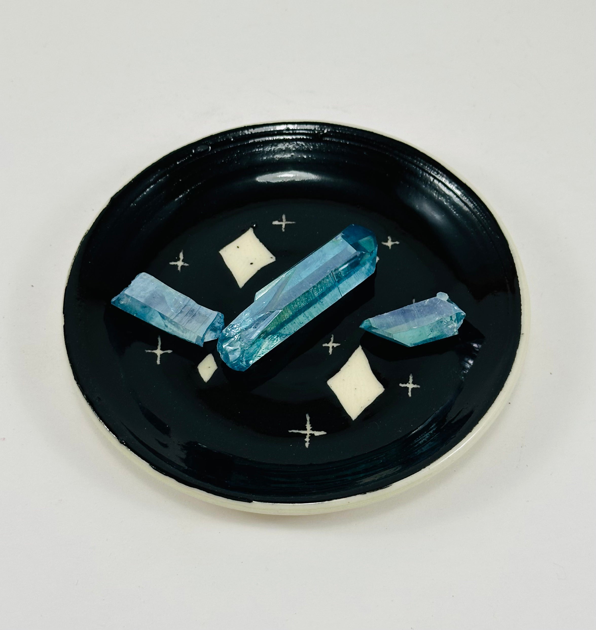 Handmade trinket dish in  black and white glaze with stars.