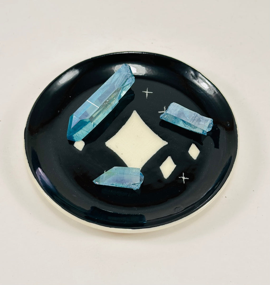 Handmade trinket dish in black and white glaze with stars.