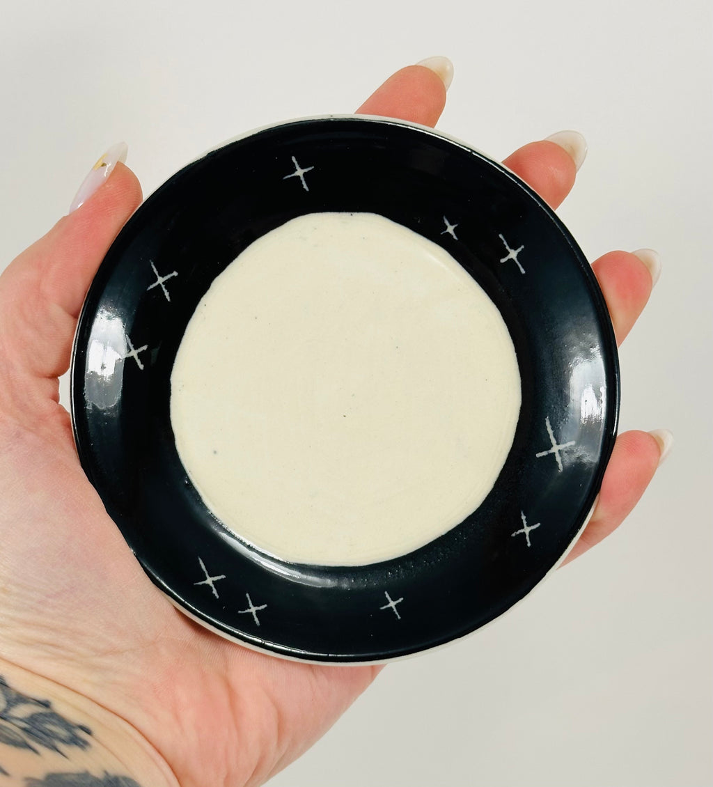 Handmade trinket dish in black and white glaze with stars and moon.