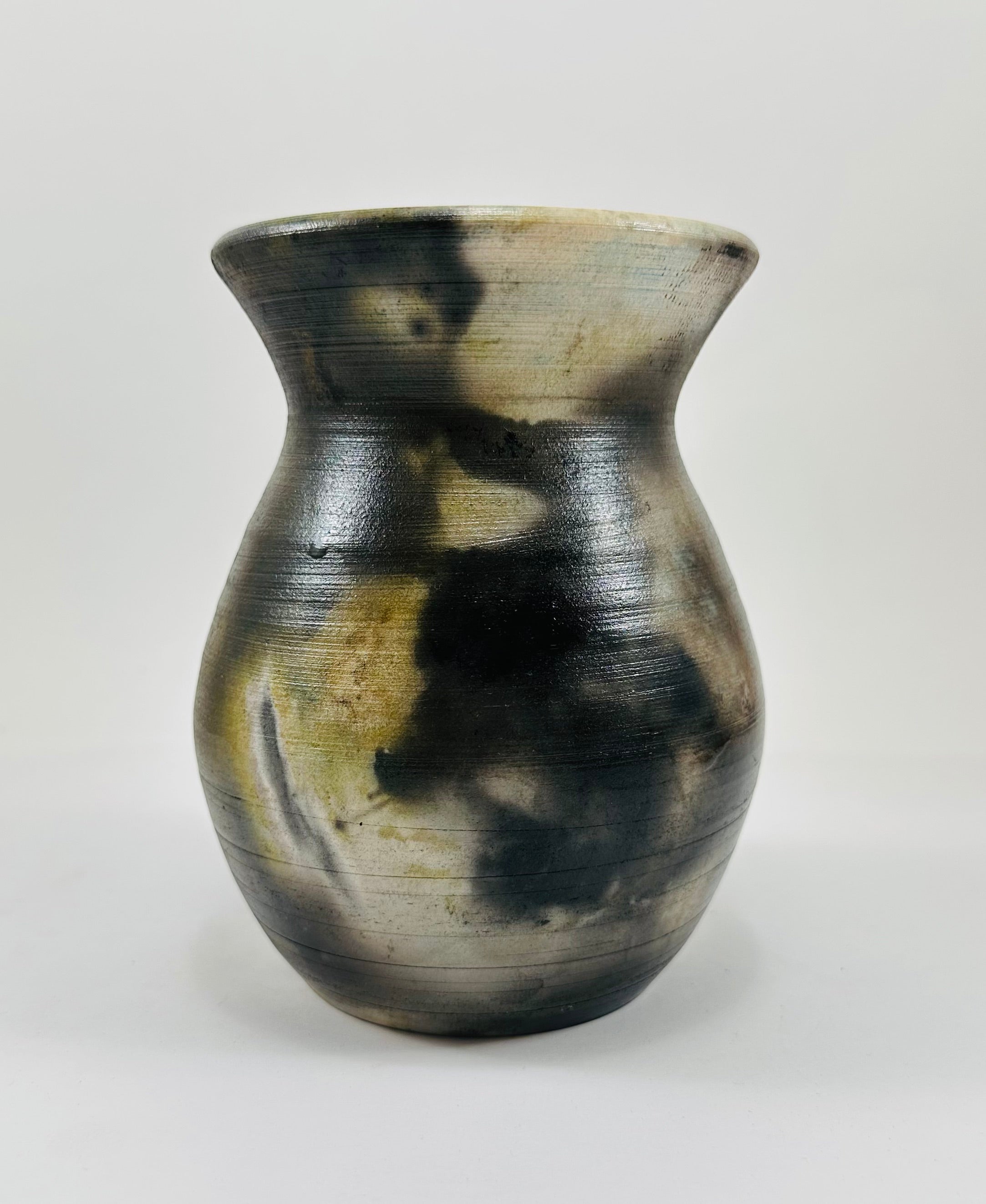 Handmade vase with a brown, white, black and yellow smokey finish.