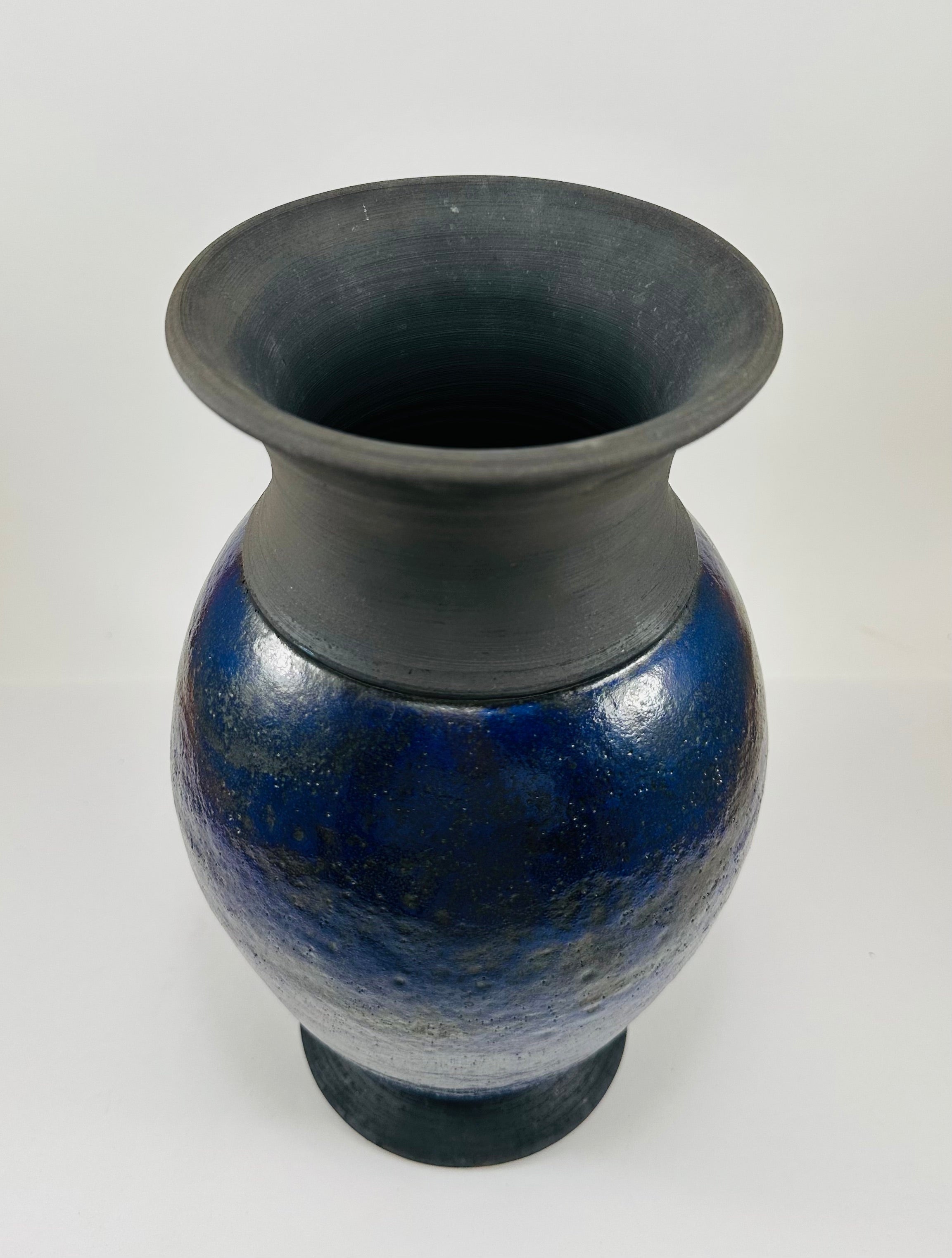 Handmade Raku vase in a beautiful purple glaze set against the raw, smokey black clay