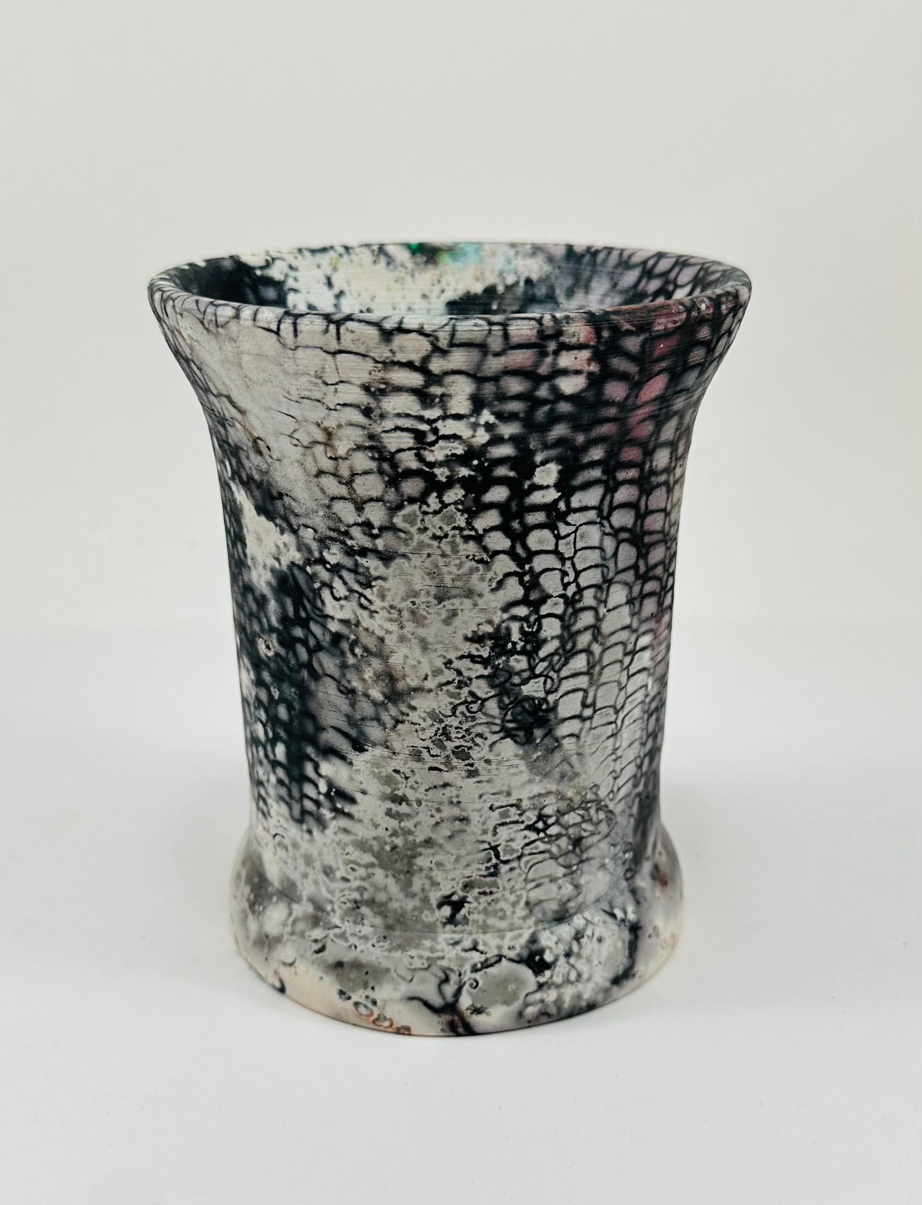 Handmade vase with a brown, white, black, red, blue and yellow smokey finish.