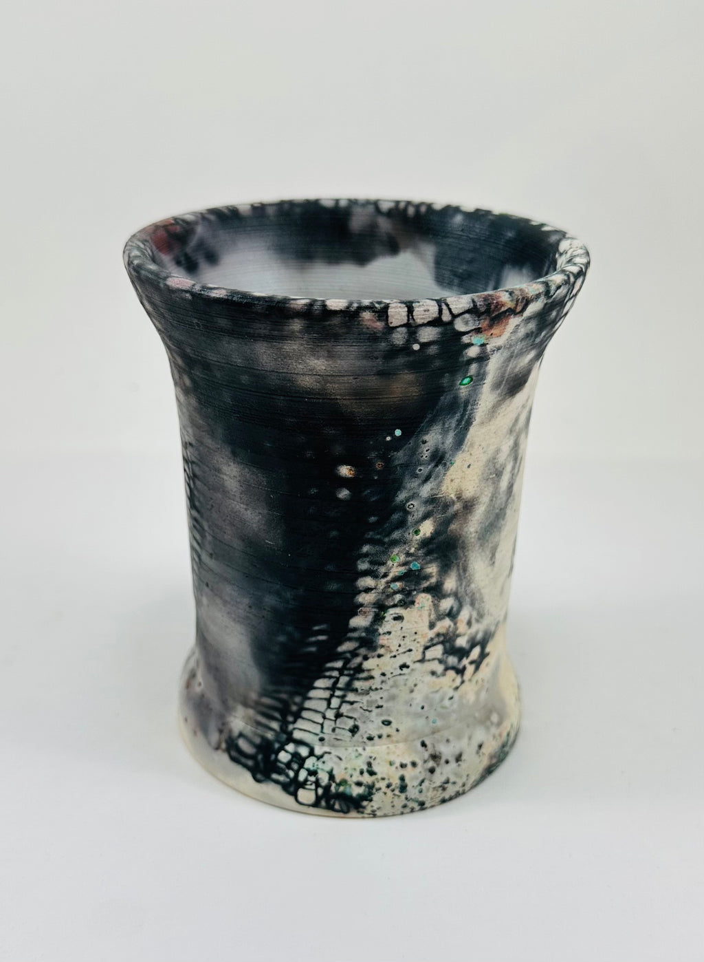 Handmade vase with a brown, white, black, red, blue and yellow smokey finish.