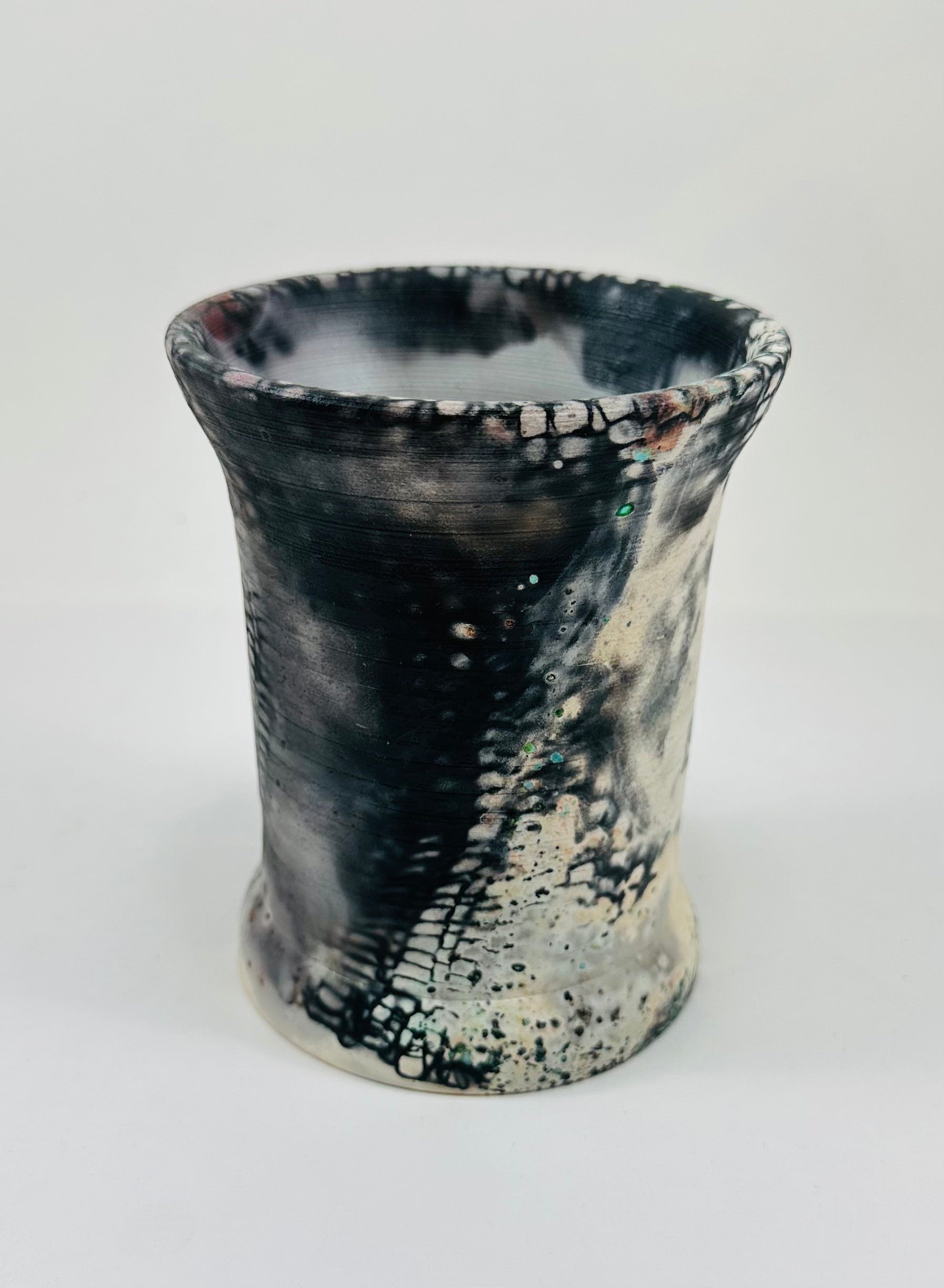 Handmade vase with a brown, white, black, red, blue and yellow smokey finish.