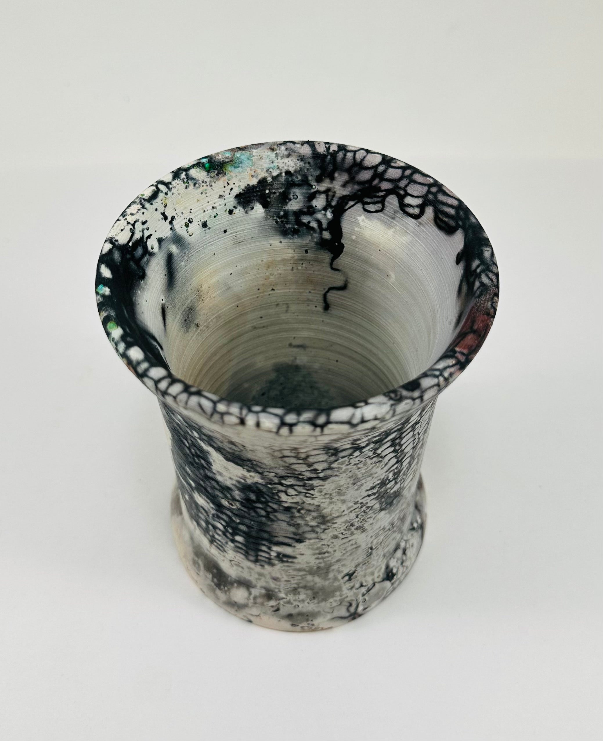 Handmade vase with a brown, white, black, red, blue and yellow smokey finish.