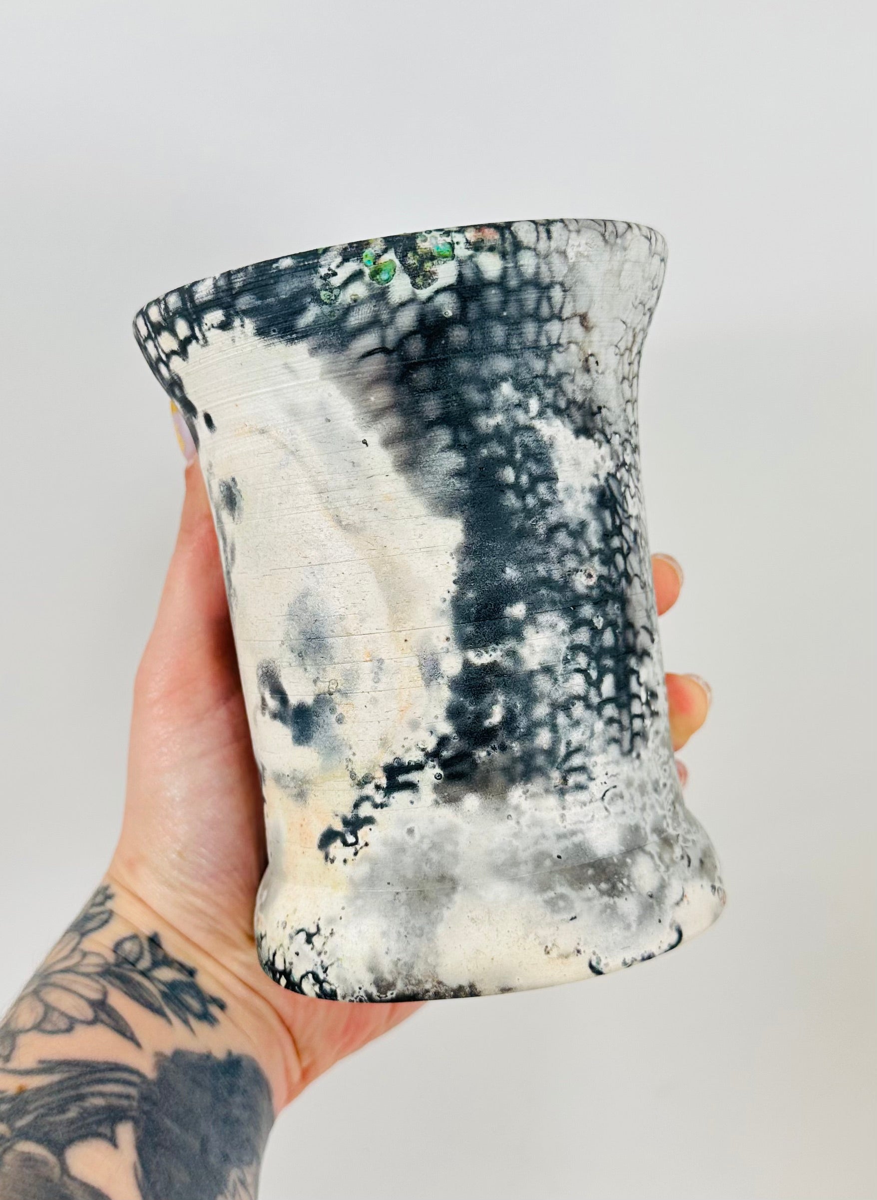 Handmade vase with a brown, white, black, red, blue and yellow smokey finish.
