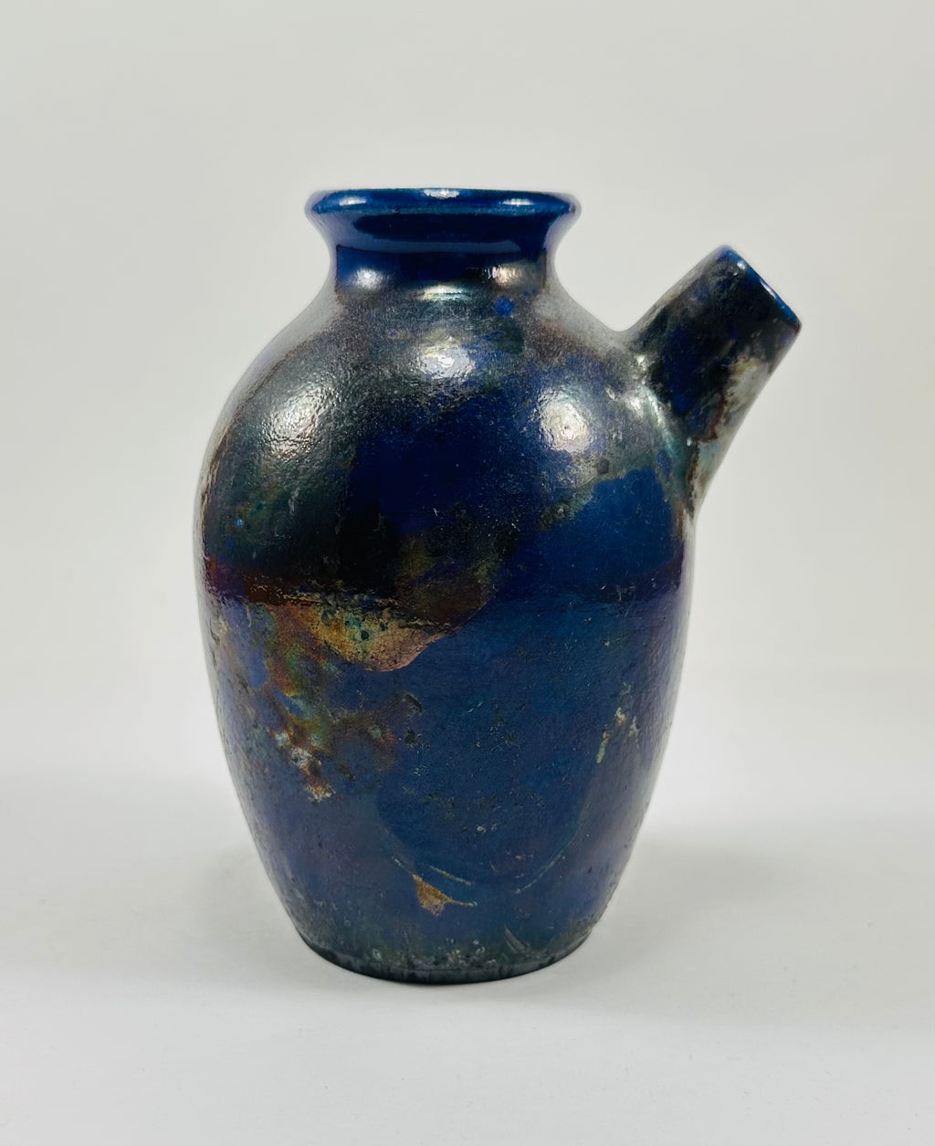 Handmade raku vase in a beautiful purple and black glaze.