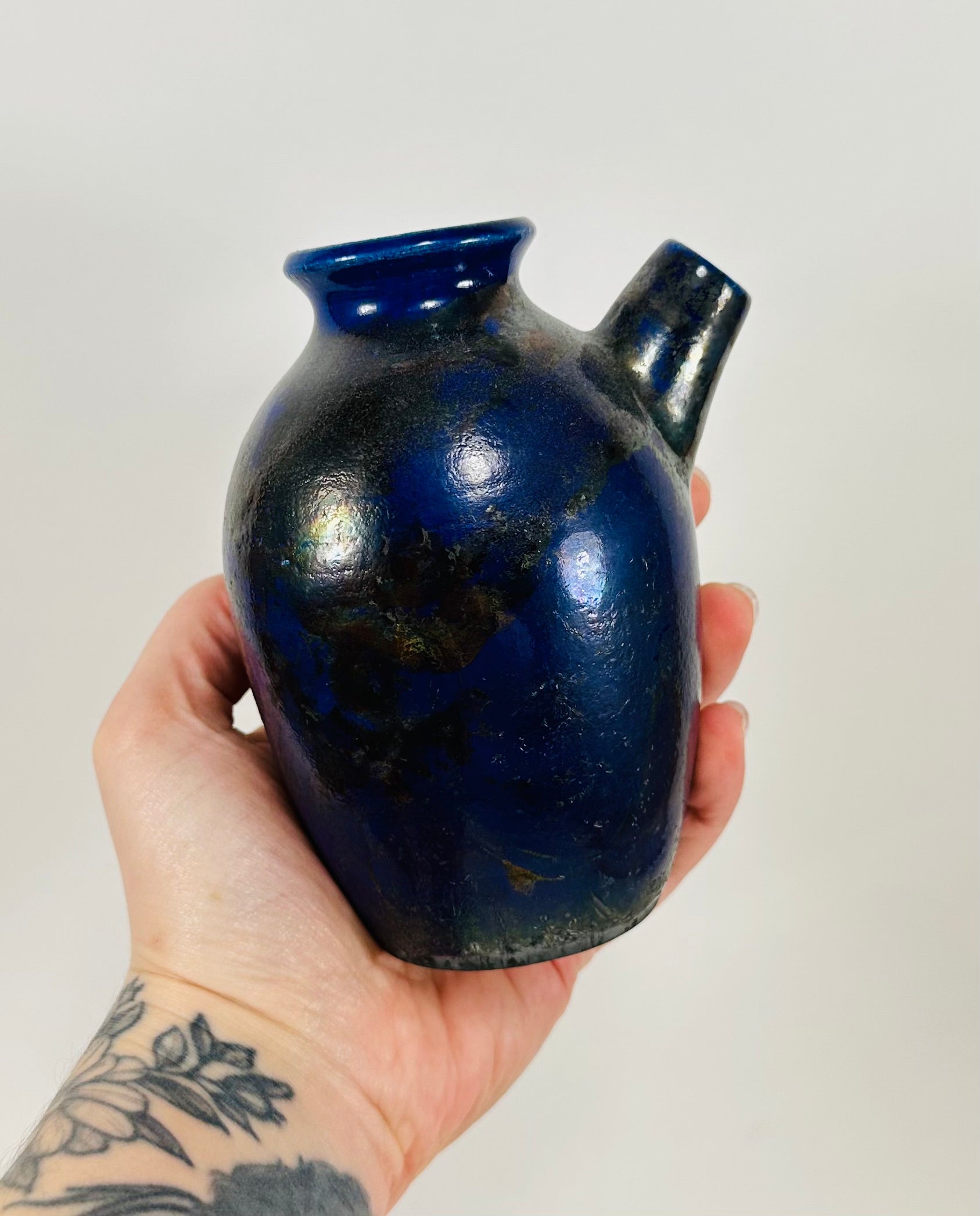 Handmade raku vase in a beautiful purple and black glaze.