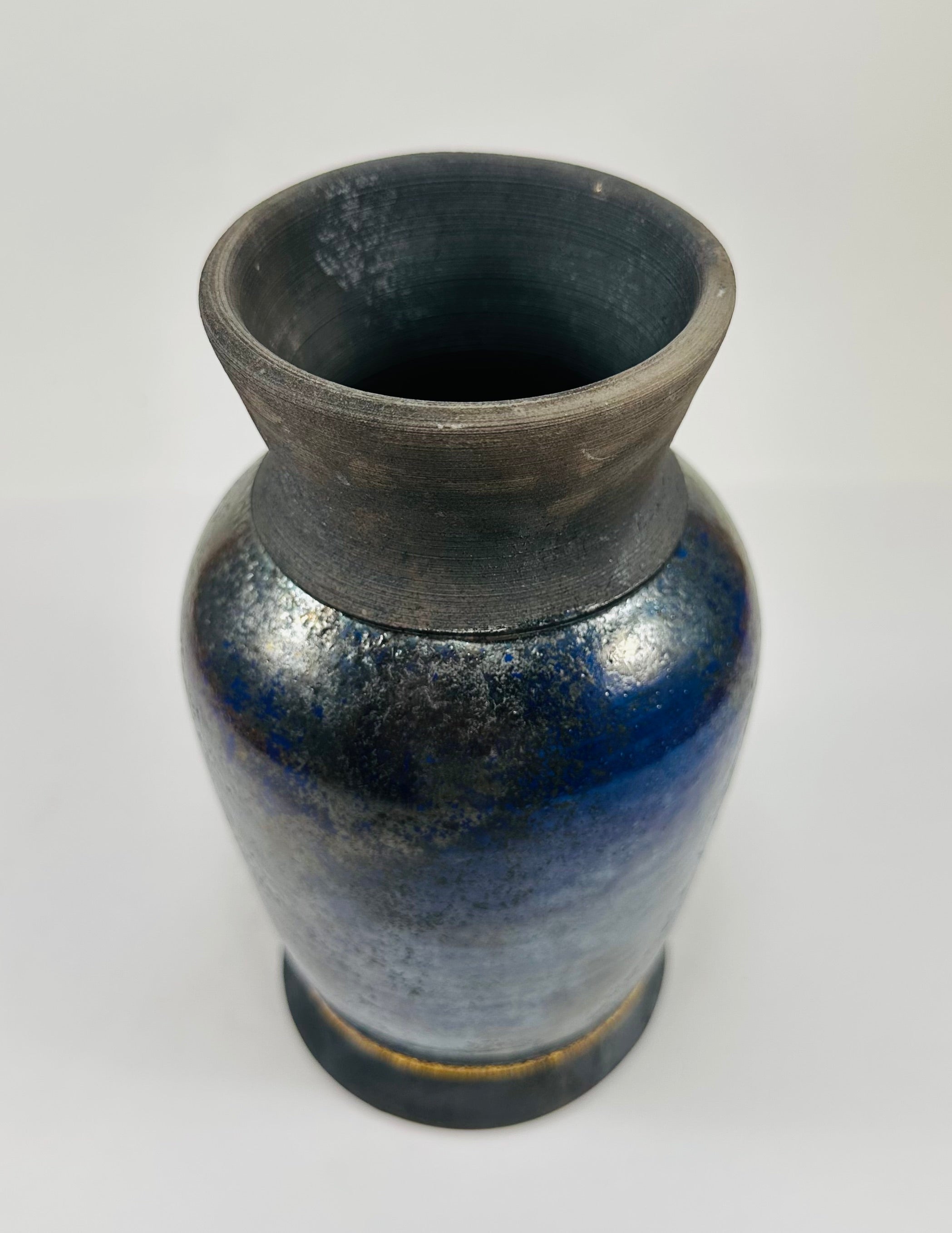 Handmade raku vase in a beautiful blue and black glaze.