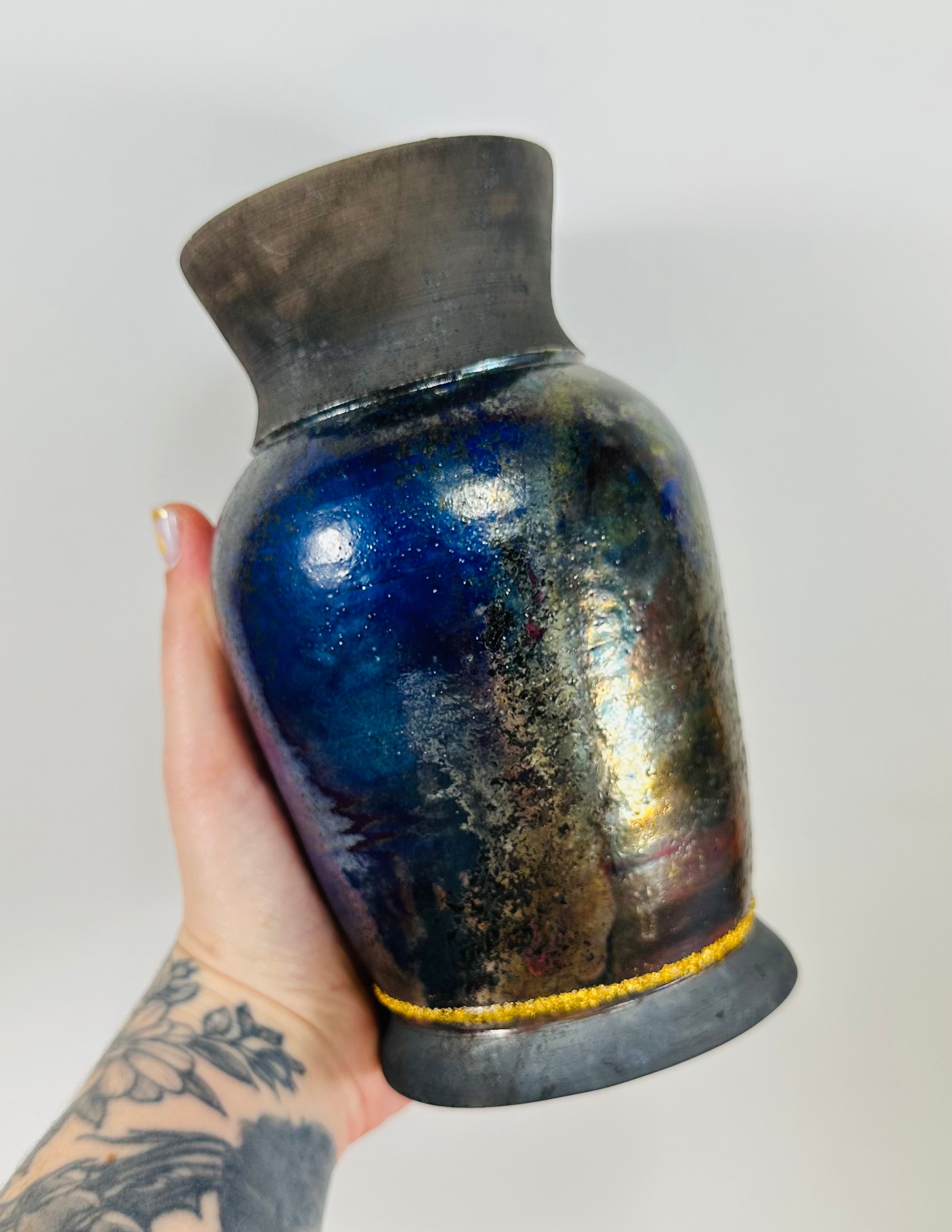 Handmade raku vase in a beautiful blue and black glaze.