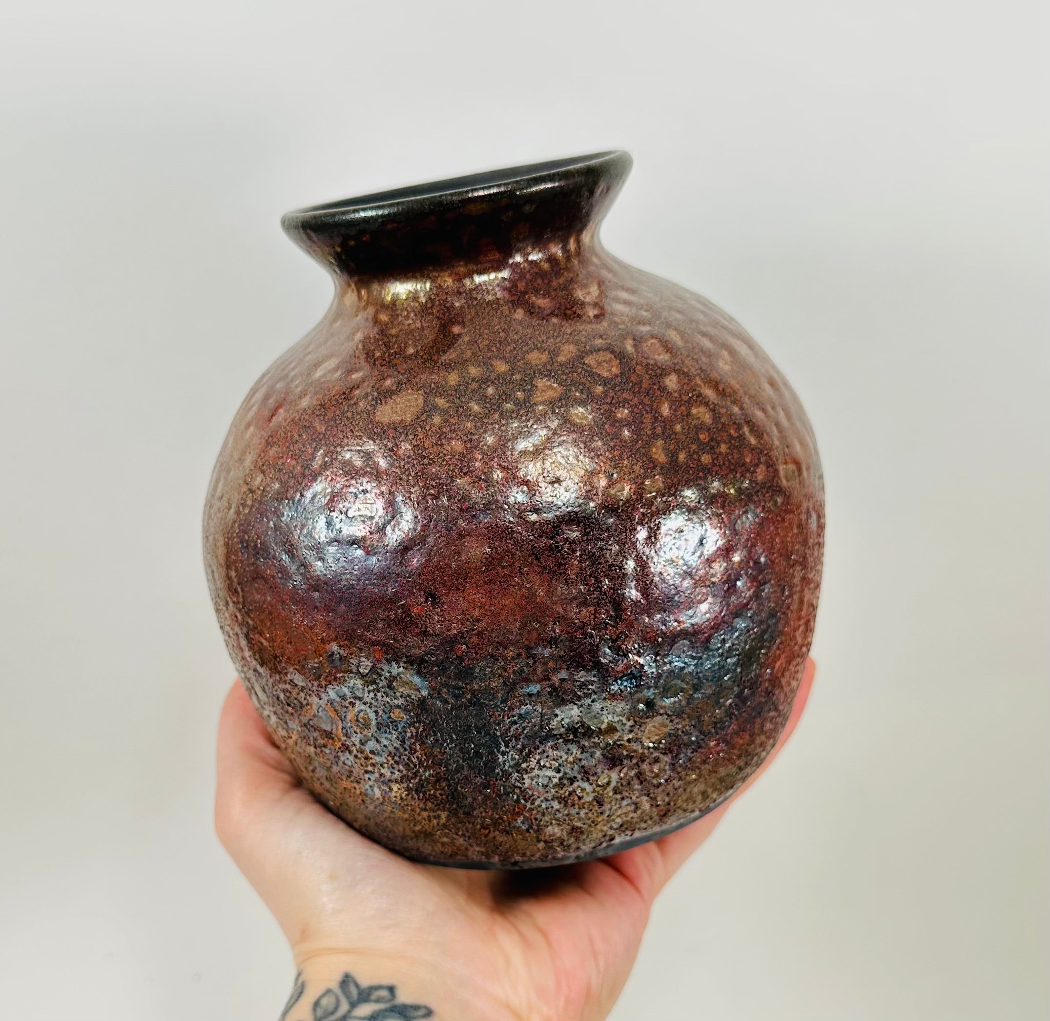 Handmade raku vase in a beautiful red and black glaze.