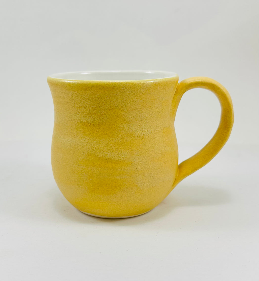 handmade ceramic mug in a beautiful yellow glaze with a capybara illustration on it