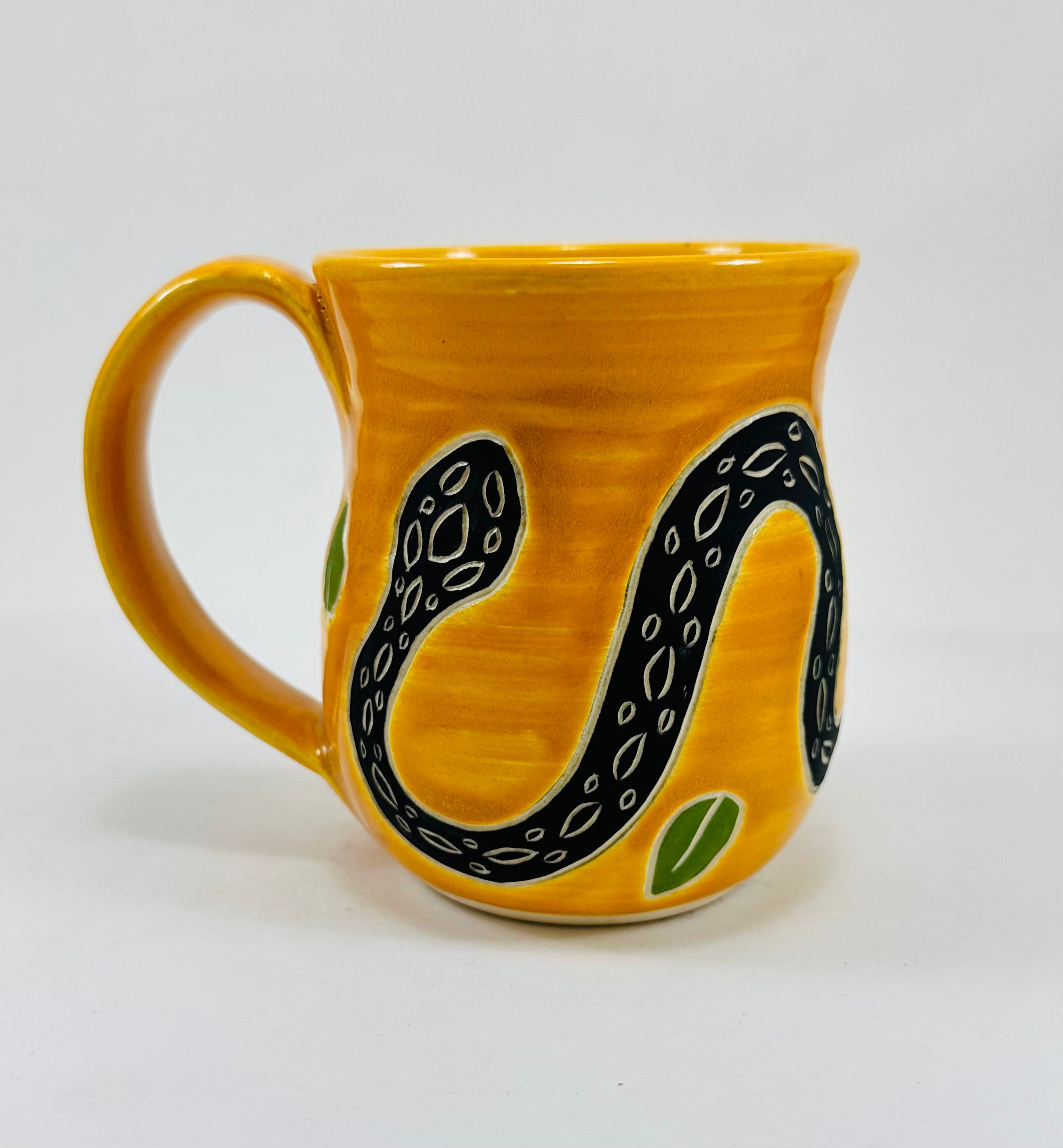 handmade ceramic mug in a beautiful yellow glaze with a snake on it