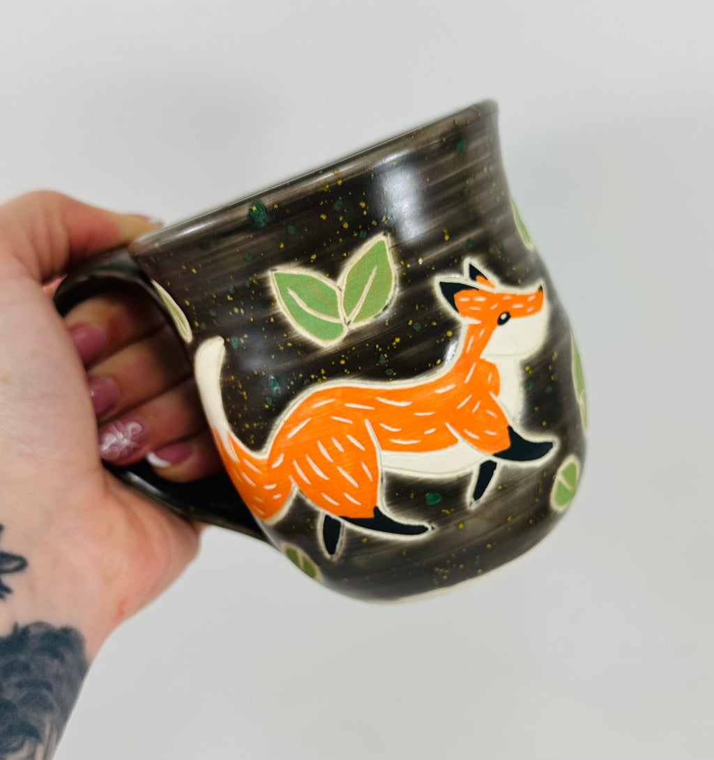 handmade ceramic mug in a beautiful brown glaze and a fox illustration on it