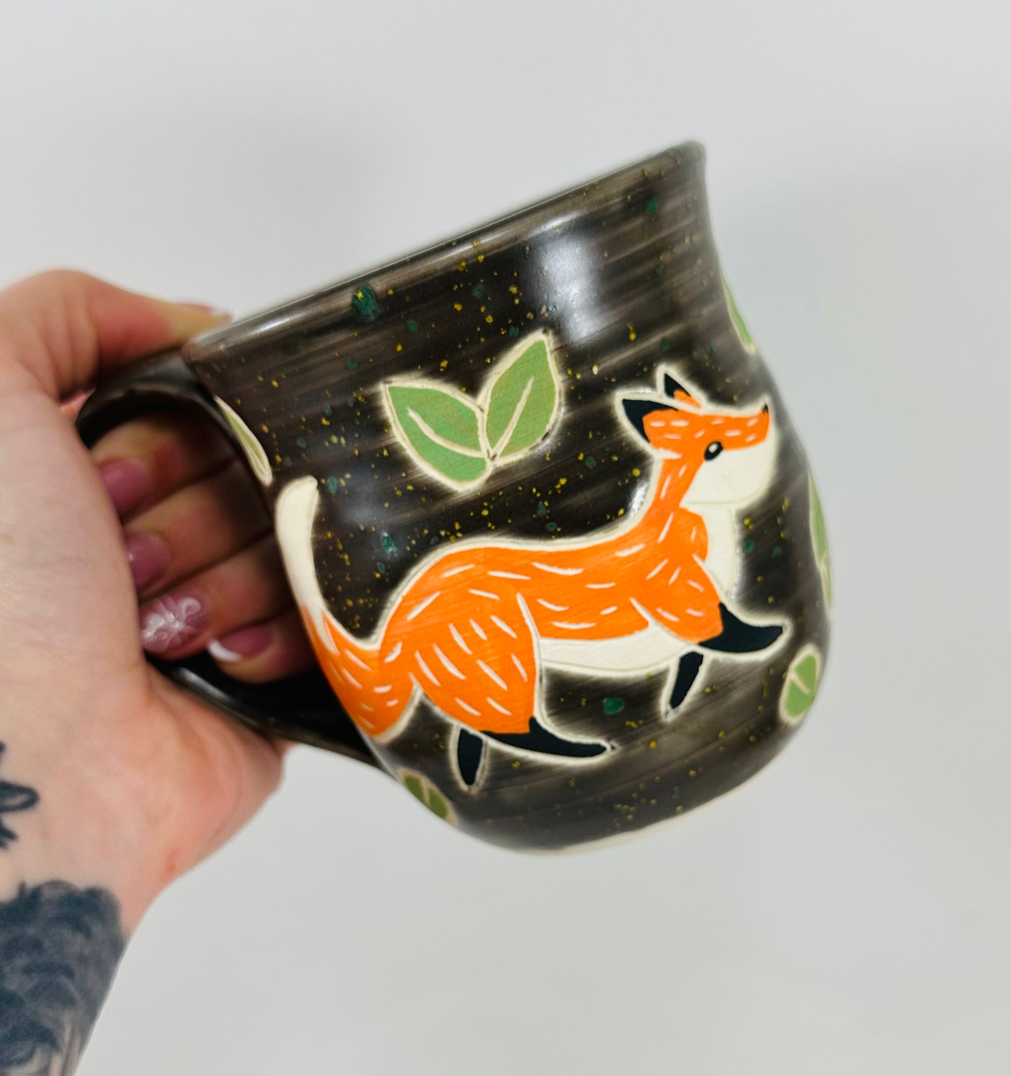 handmade ceramic mug in a beautiful brown glaze and a fox illustration on it