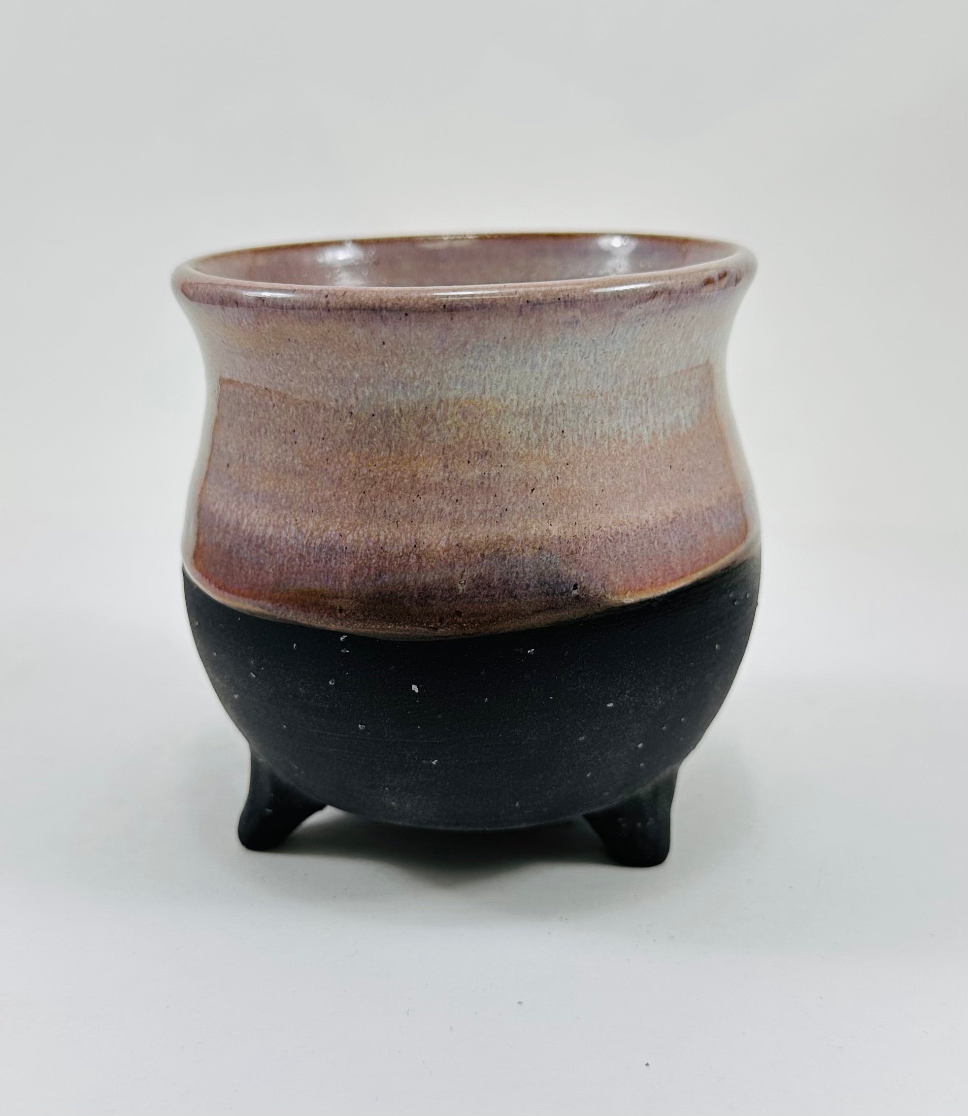 handmade ceramic cauldron mug on a beautiful purple and black glaze.