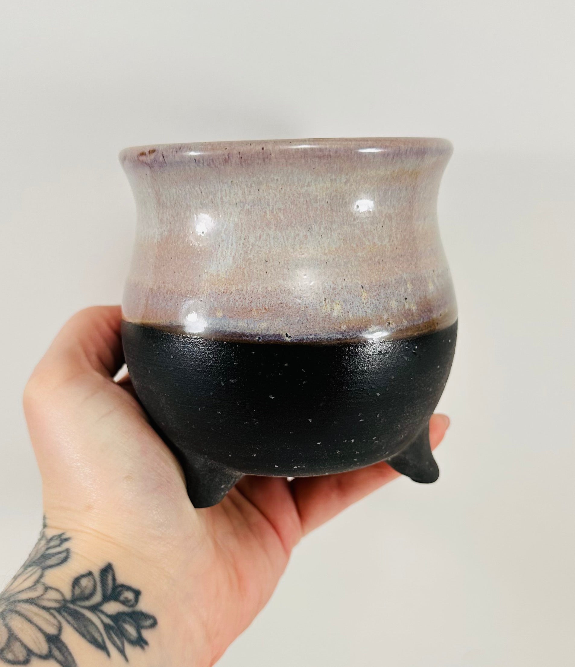 handmade ceramic cauldron mug on a beautiful purple and black glaze.