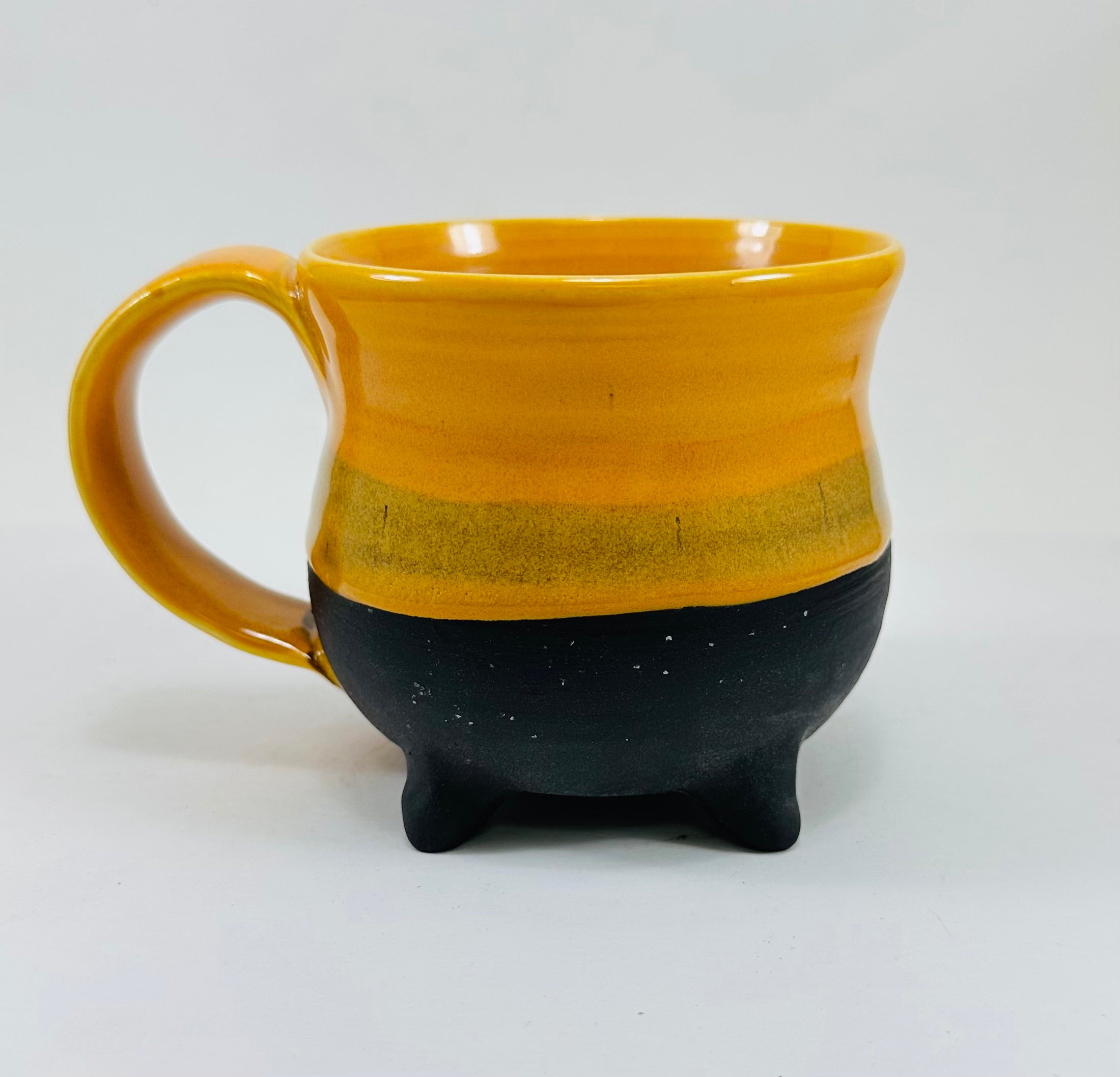 handmade ceramic cauldron mug in a beautiful yellow and black glaze