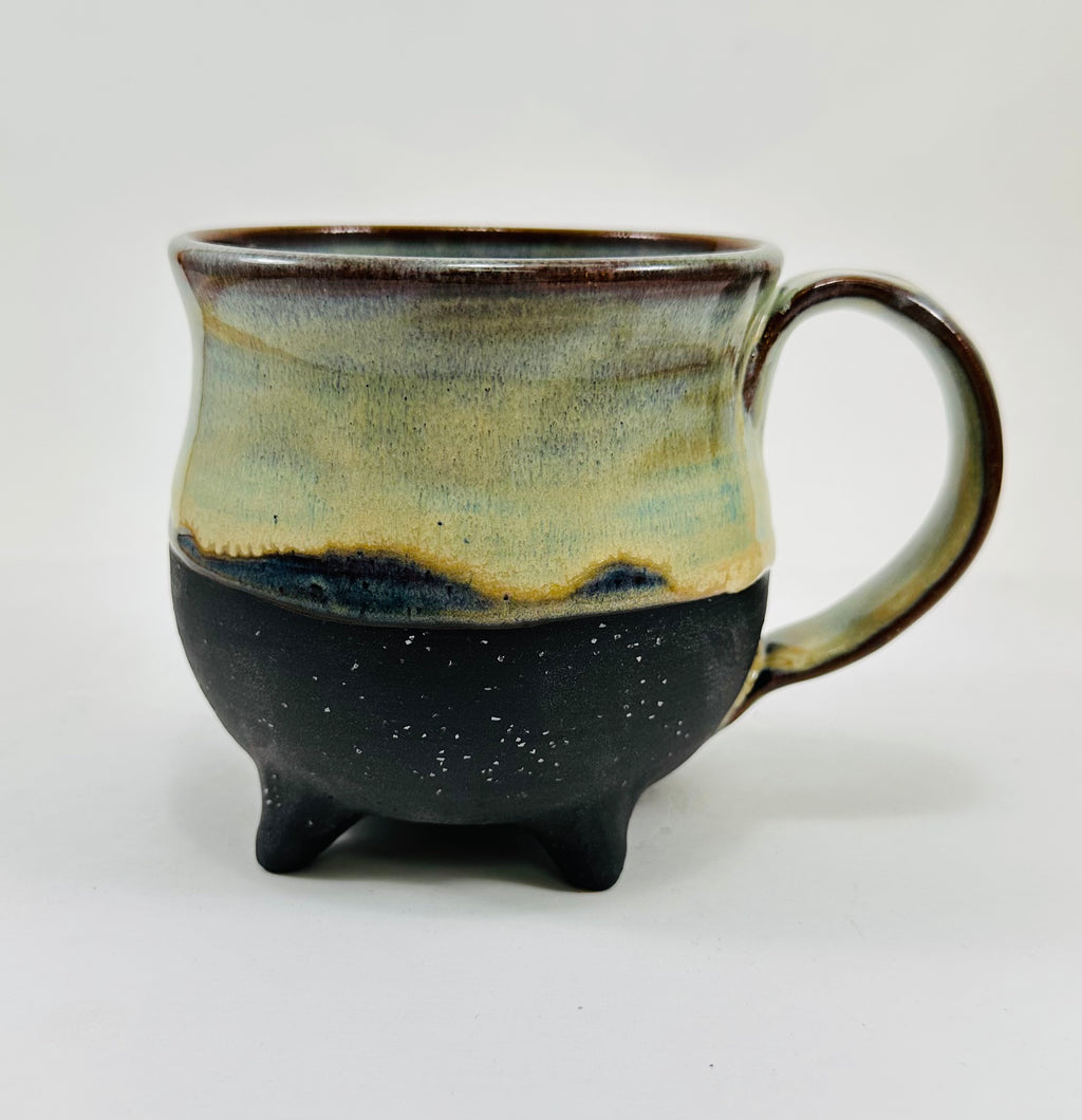 handmade ceramic cauldron mug in a beautiful green/yellow/blue/black glaze