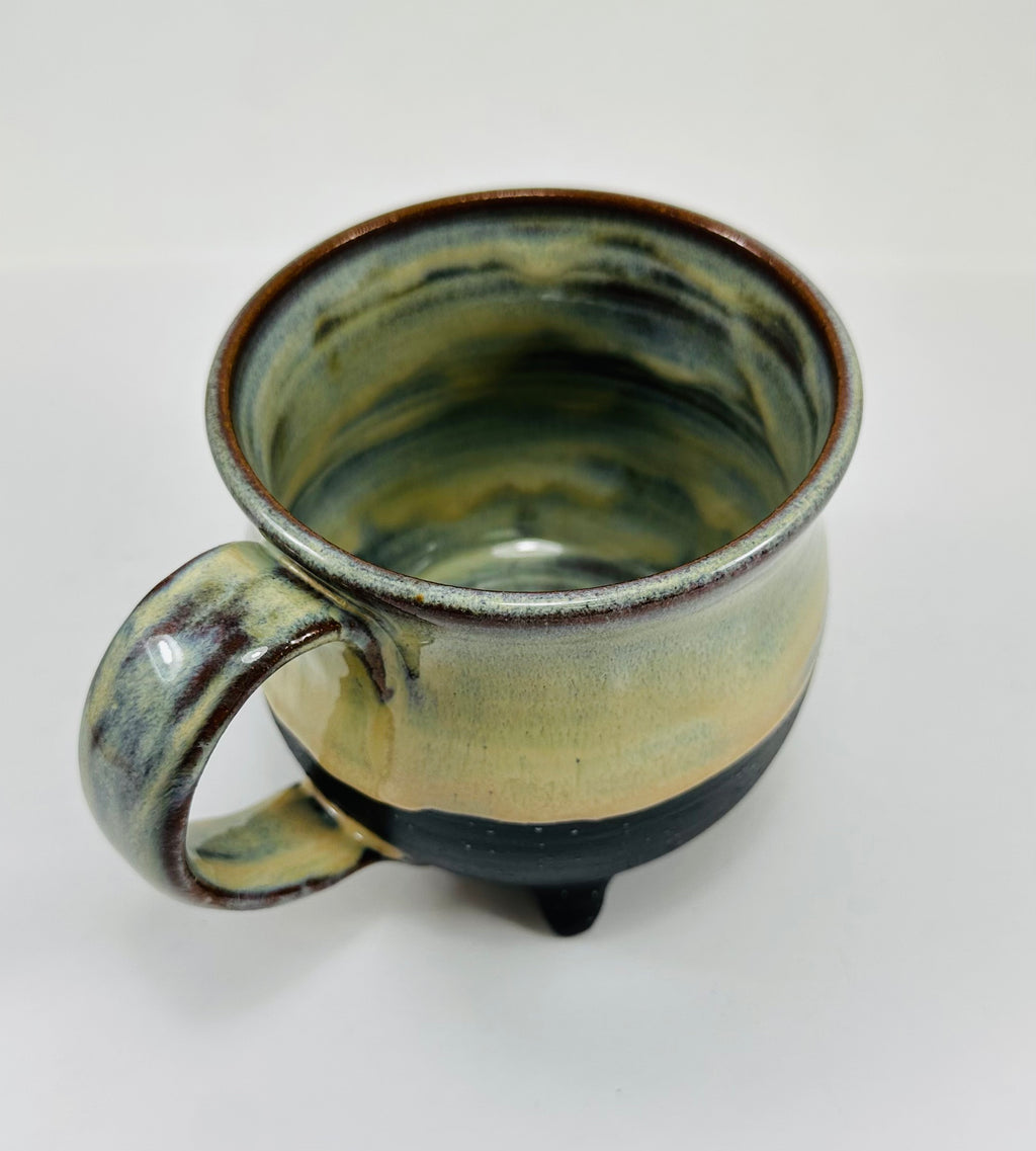 handmade ceramic cauldron mug in a beautiful green/yellow/blue/black glaze