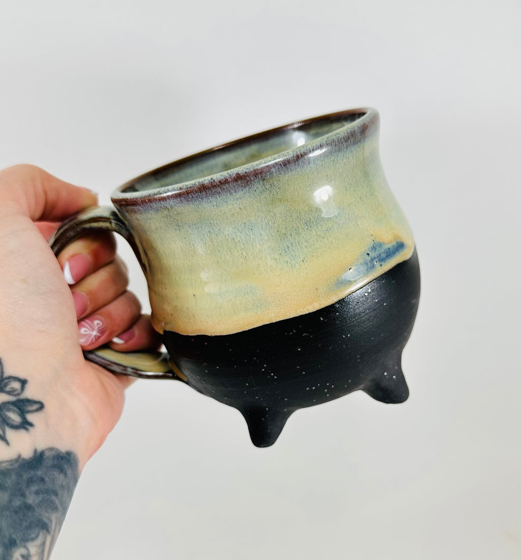 handmade ceramic cauldron mug in a beautiful green/yellow/blue/black glaze