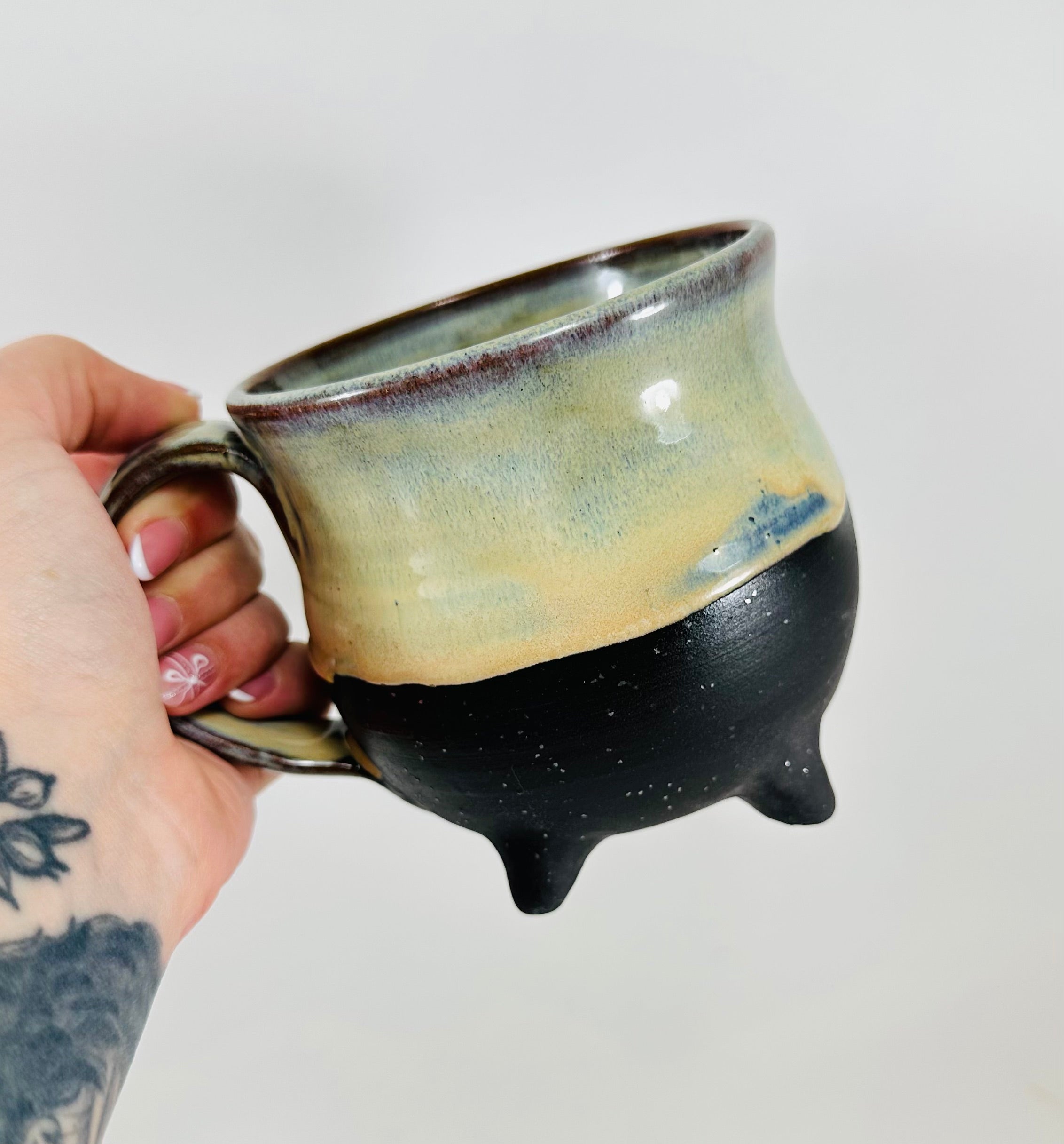 handmade ceramic cauldron mug in a beautiful green/yellow/blue/black glaze