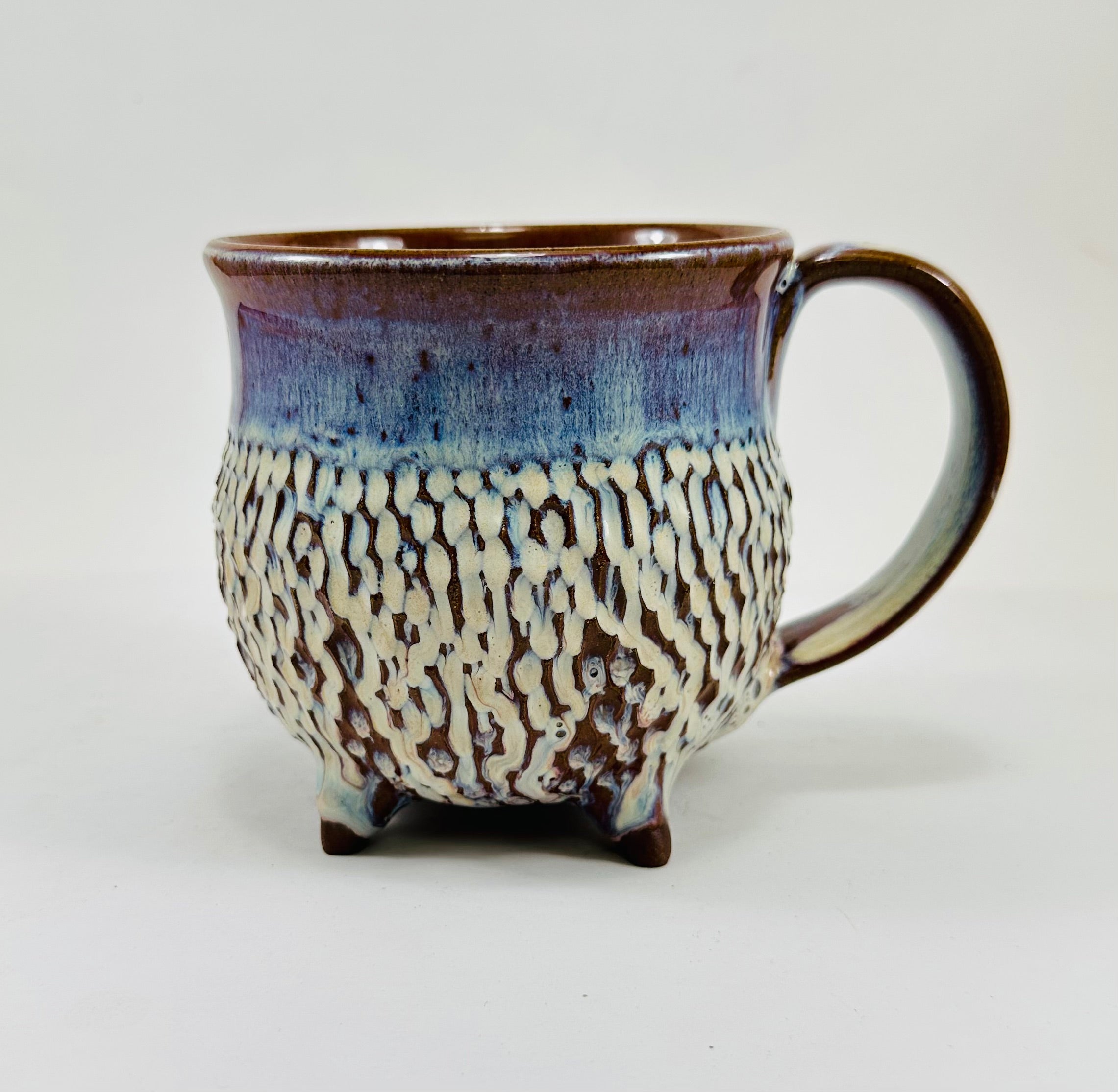 handmade ceramic cauldron mug in a beautiful blue, purple and cream glaze