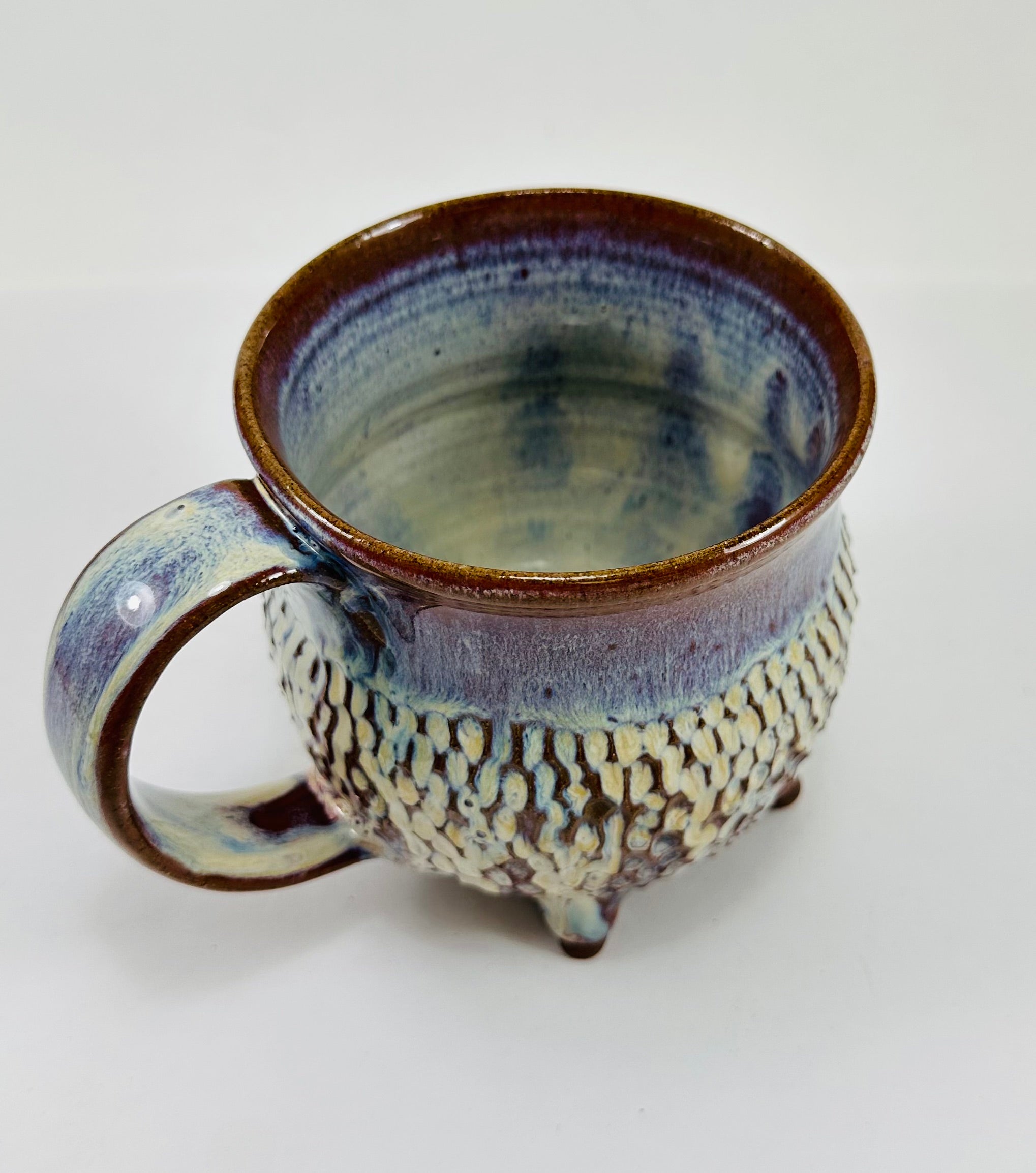 handmade ceramic cauldron mug in a beautiful blue, purple and cream glaze