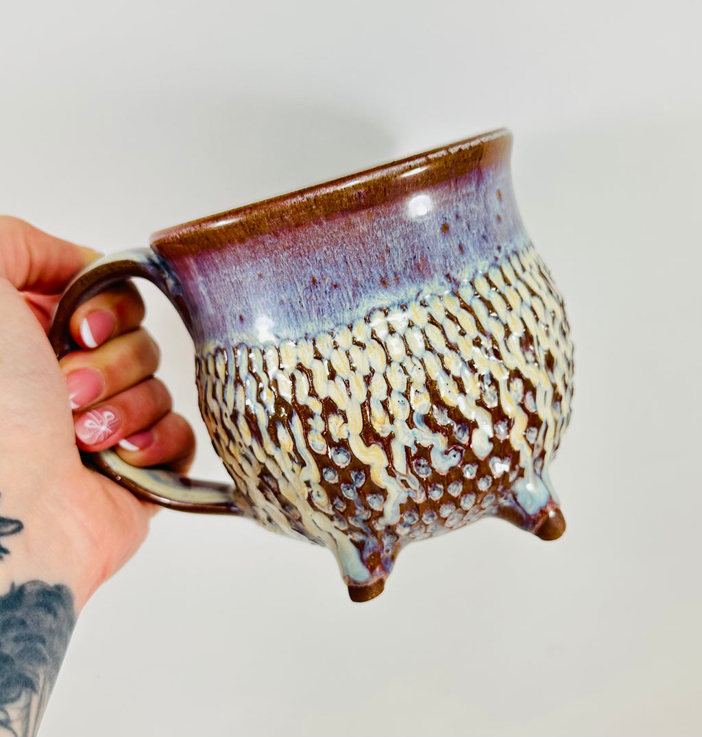 handmade ceramic cauldron mug in a beautiful blue, purple and cream glaze