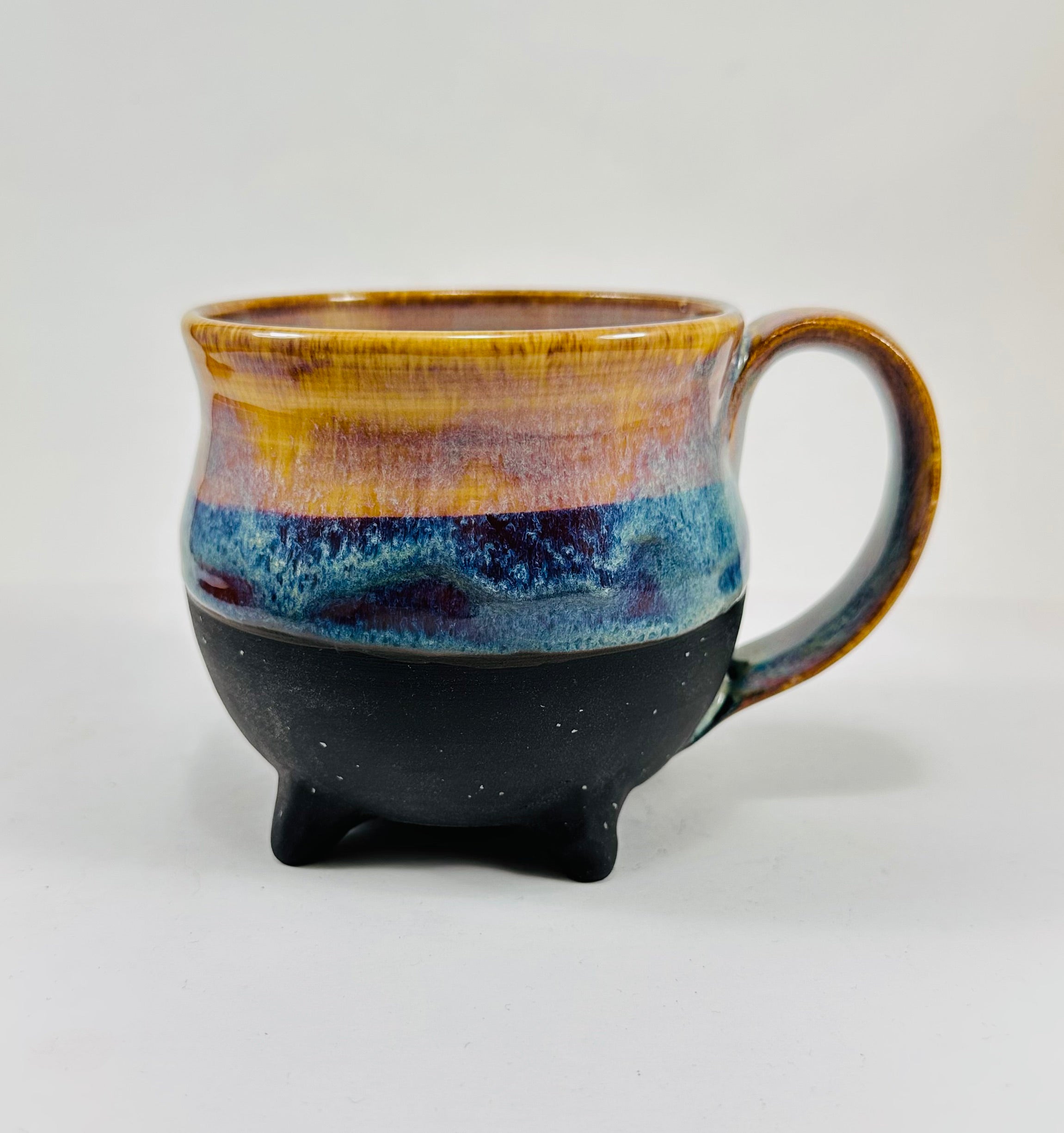 handmade cauldron mug in a beautiful amber and blue glaze