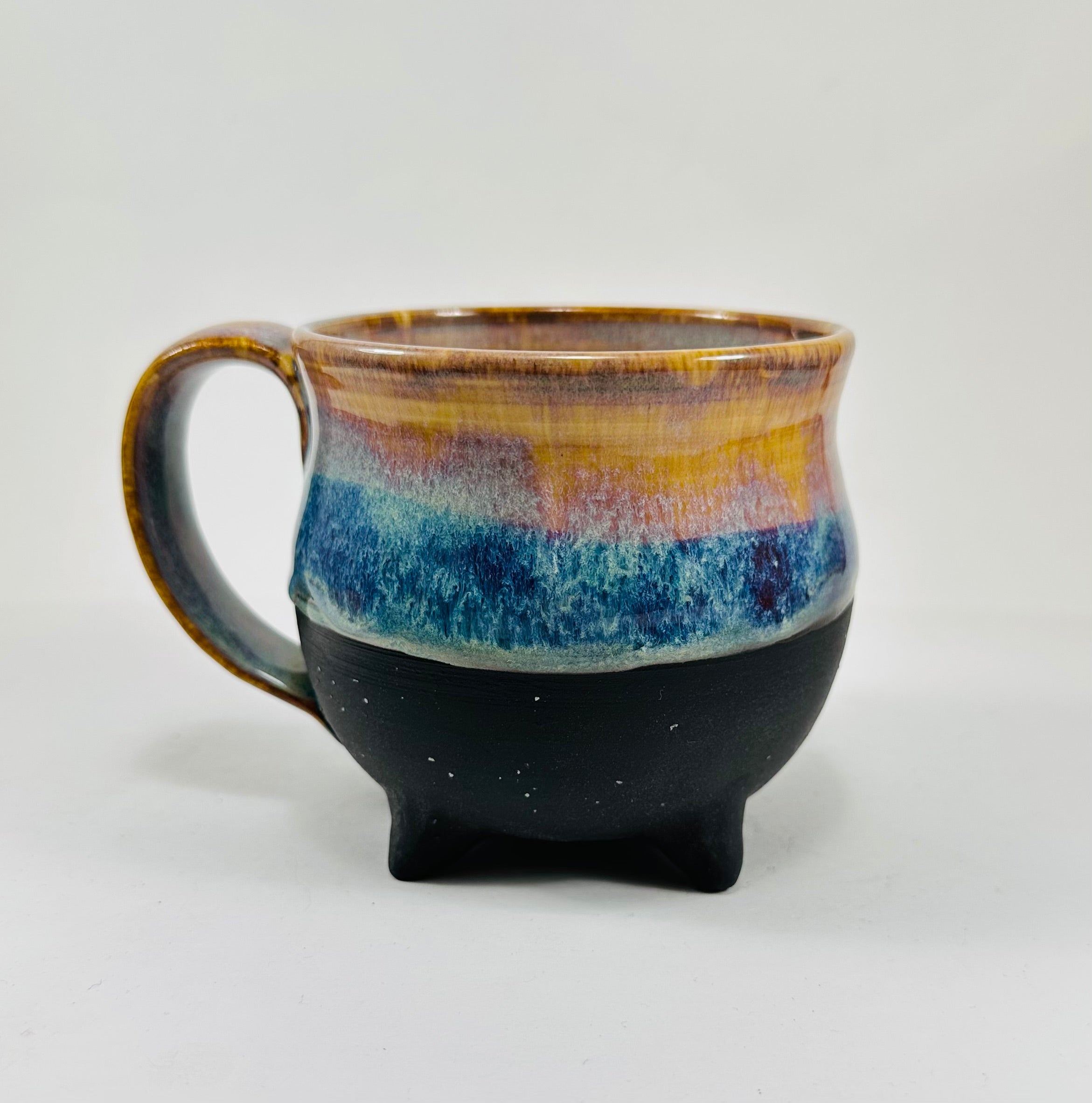handmade cauldron mug in a beautiful amber and blue glaze