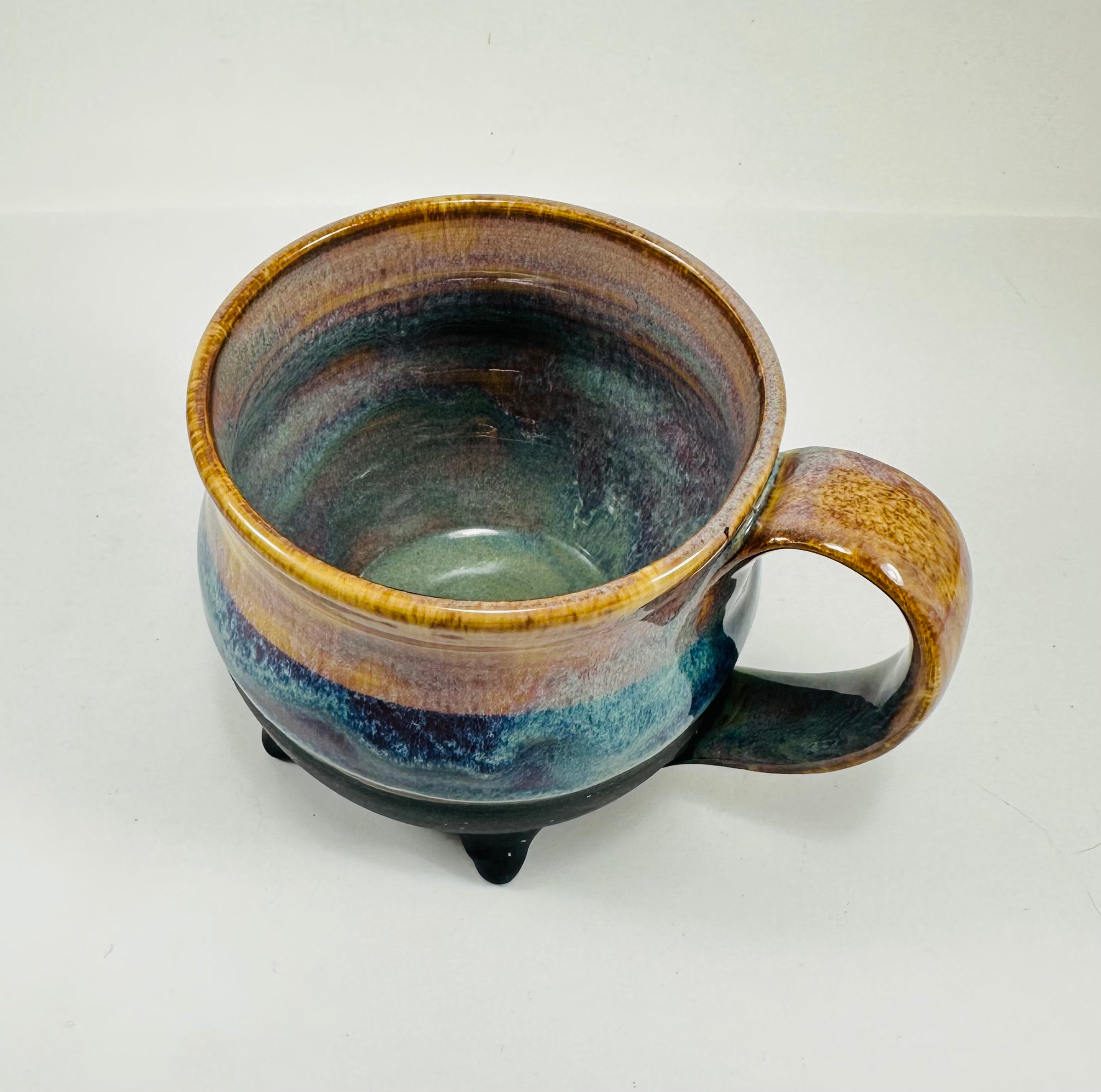 handmade cauldron mug in a beautiful amber and blue glaze