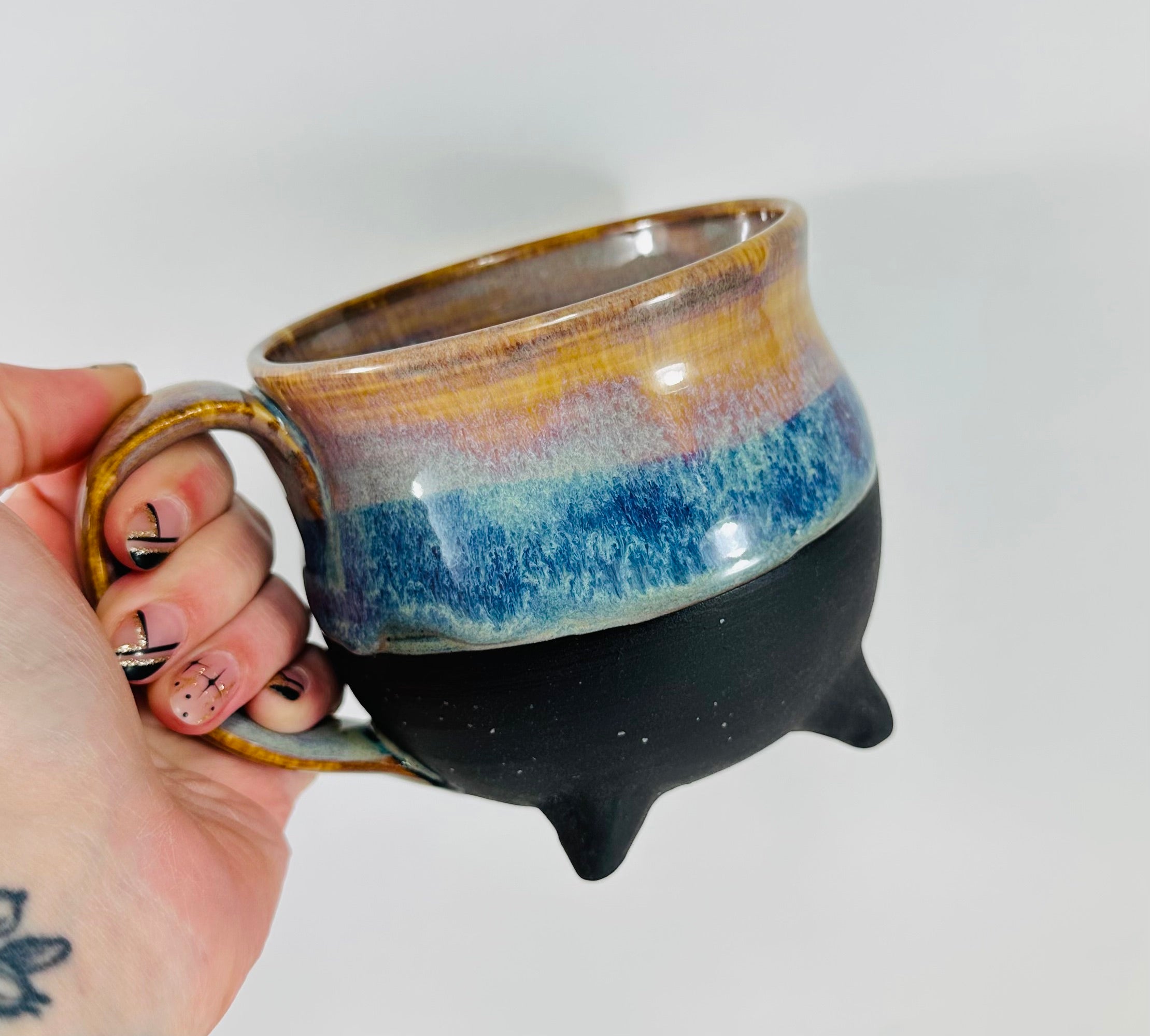 handmade cauldron mug in a beautiful amber and blue glaze