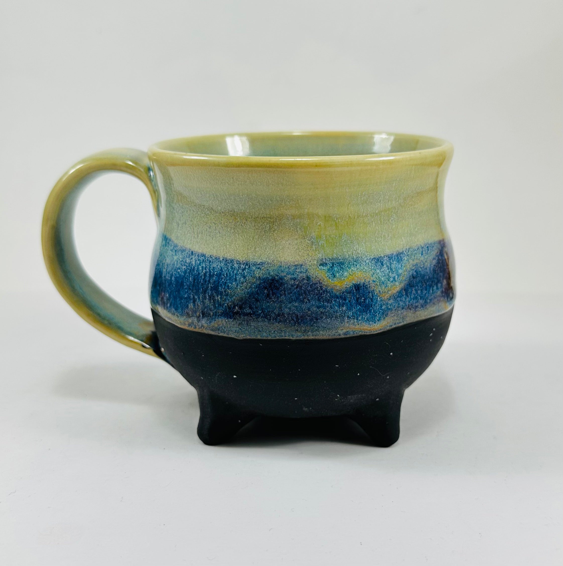 handmade cauldron mug in a beautiful green and blue glaze